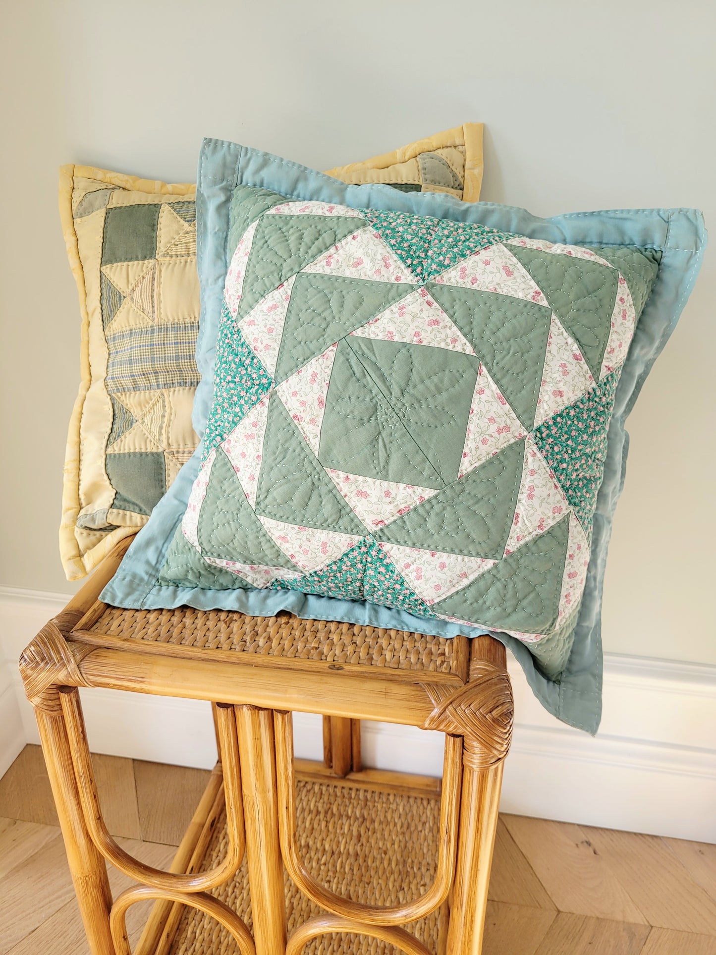 front view of quilted cushions in green and yellow hues and pattern