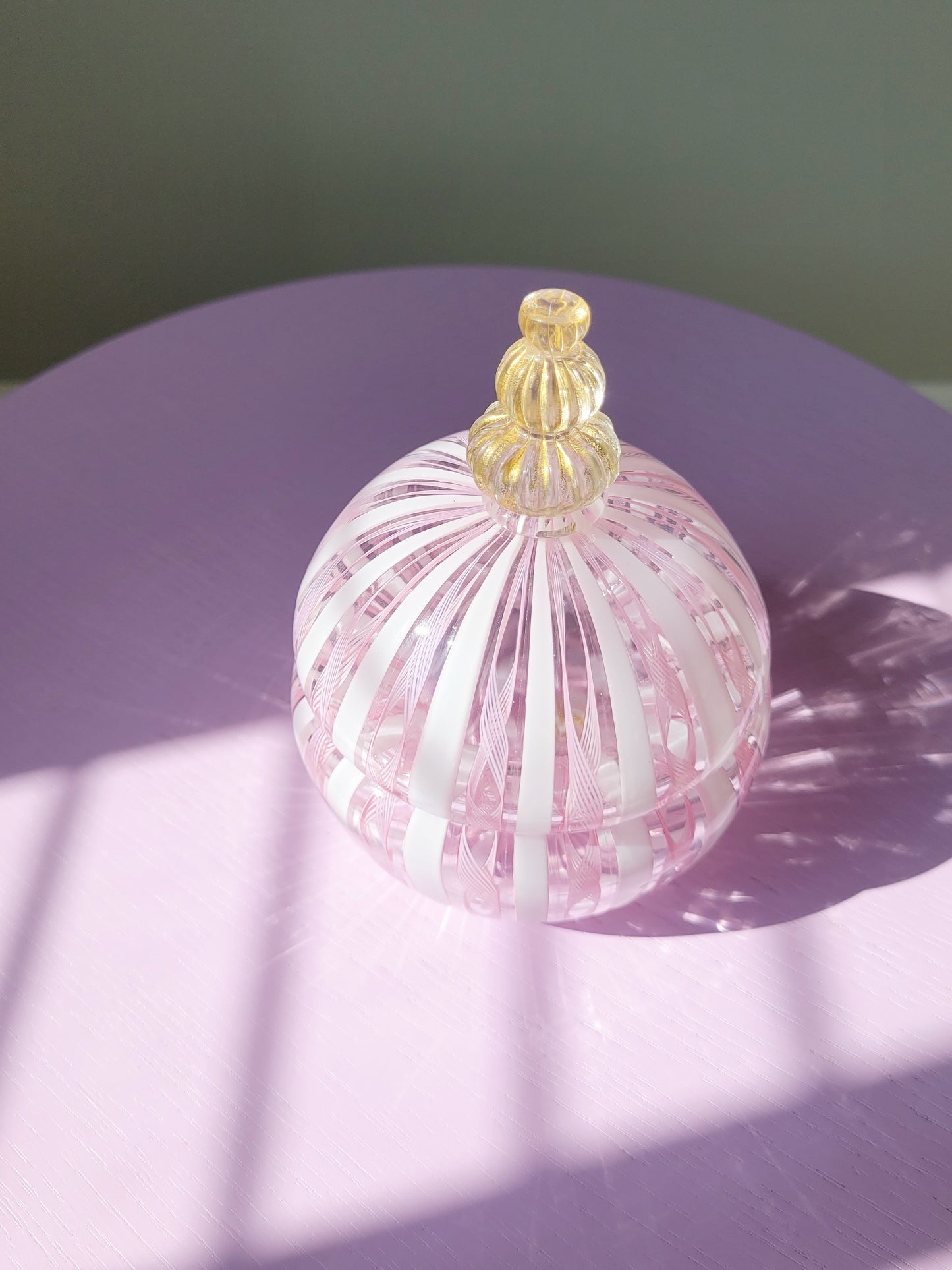 top view of a handcrafted vintage striped Murano bonbonniere in pink white and gold