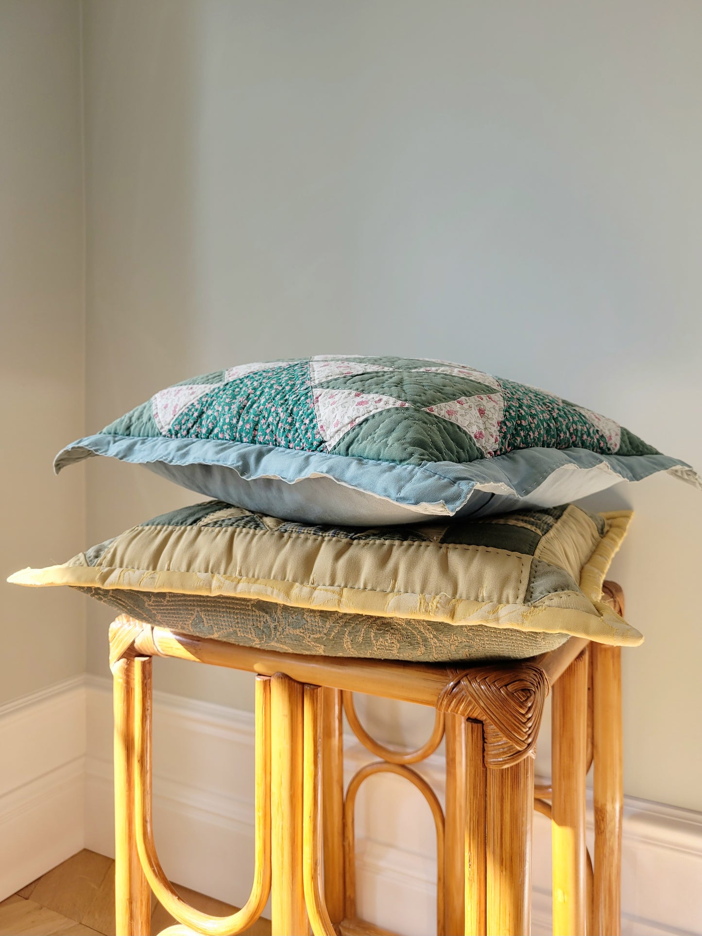 side view of quilted cushions in green and yellow hues and pattern
