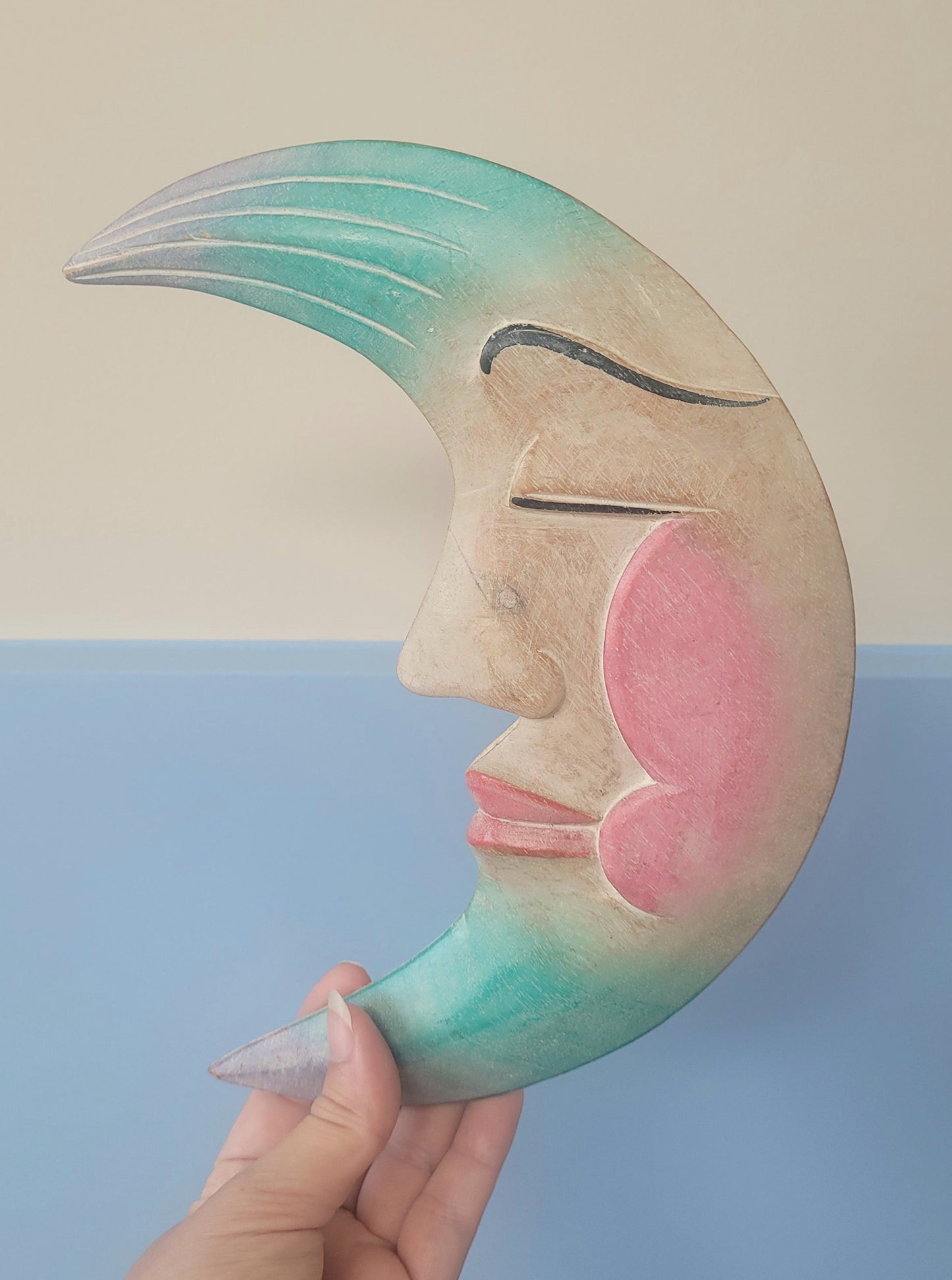 front view of a carved crescent moon to hang in a children's room