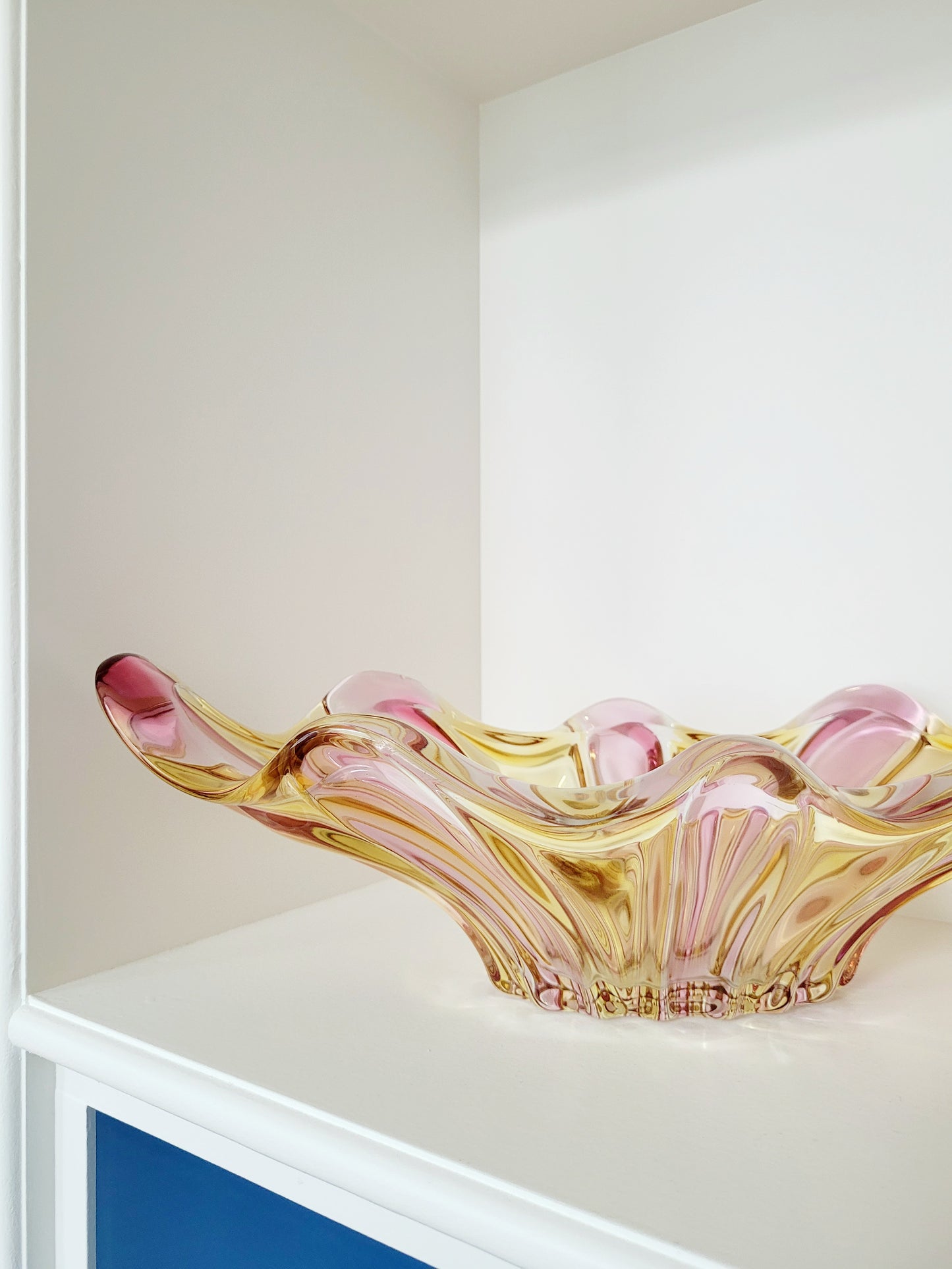 side view of a vibrant candy coloured glass serving or trinket bowl in yellow and pink