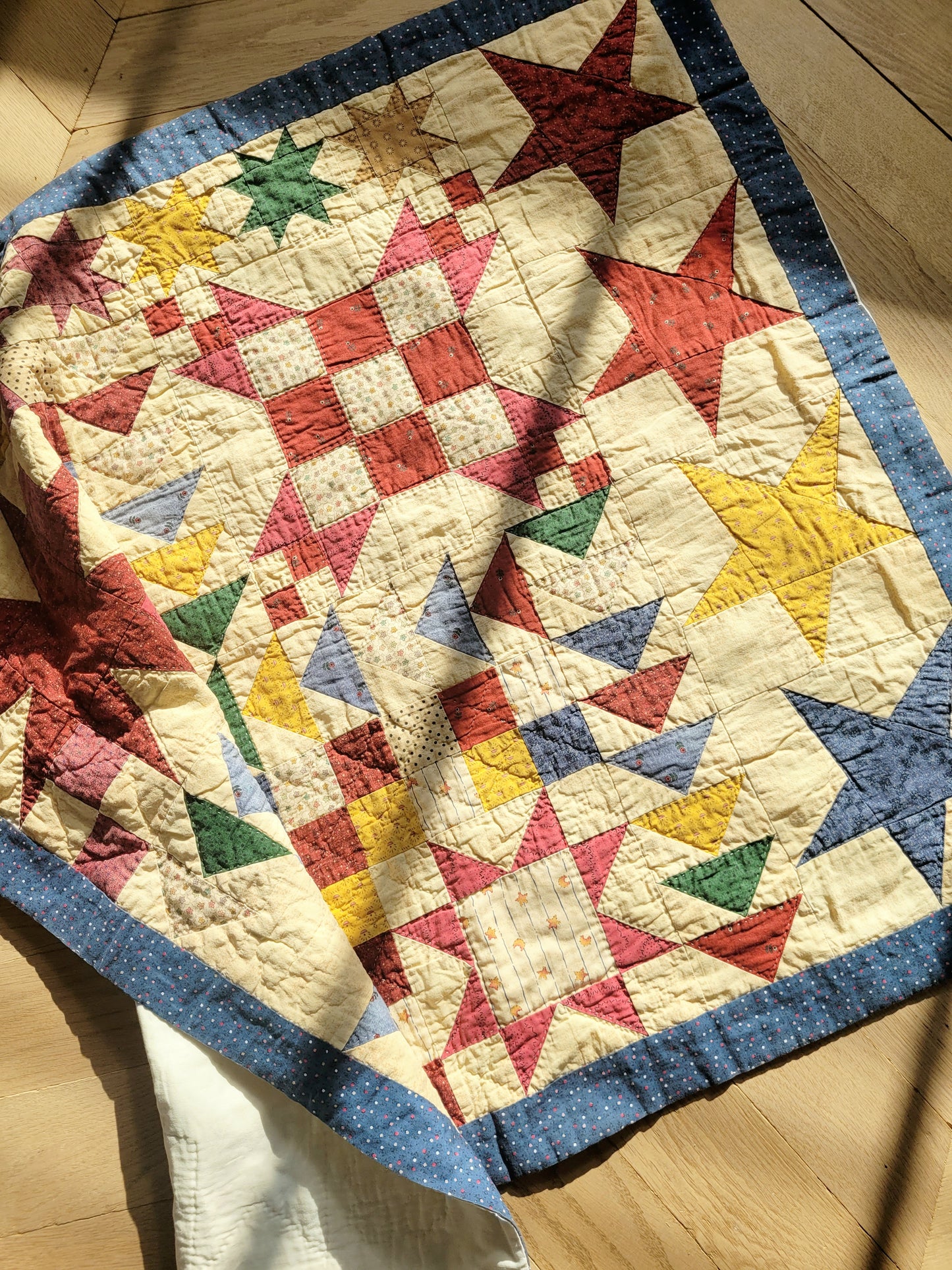 top view of a colourful patchwork quilt with geometrical pattern