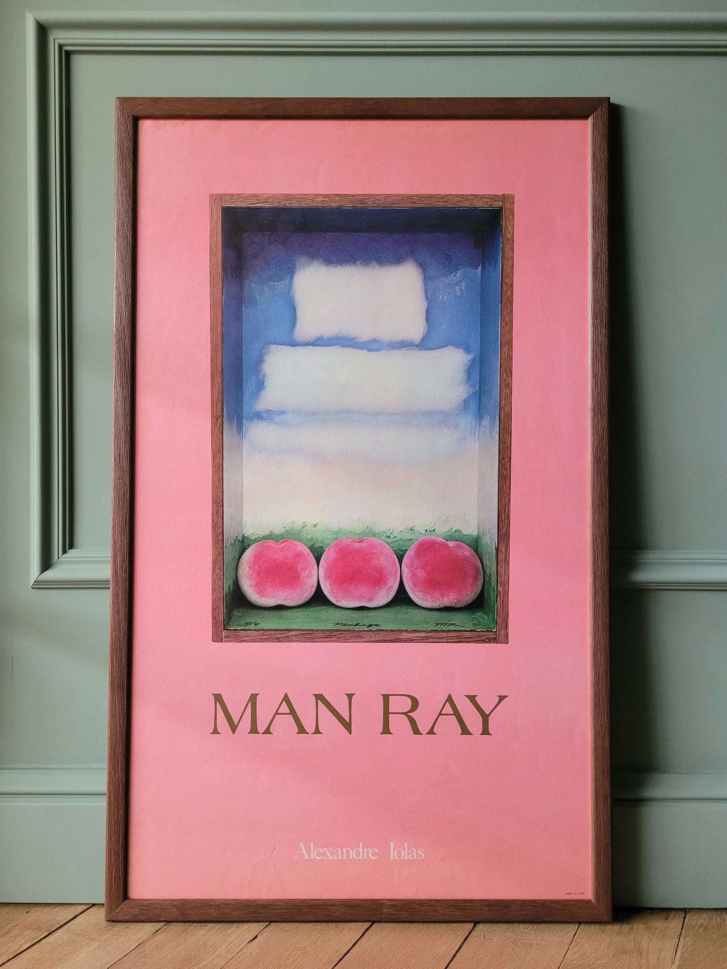 front view of an authentic original exhibition poster from the Man Ray exhibition at the Alexandre Iolas Gallery, depicting his "Three peaches"-work