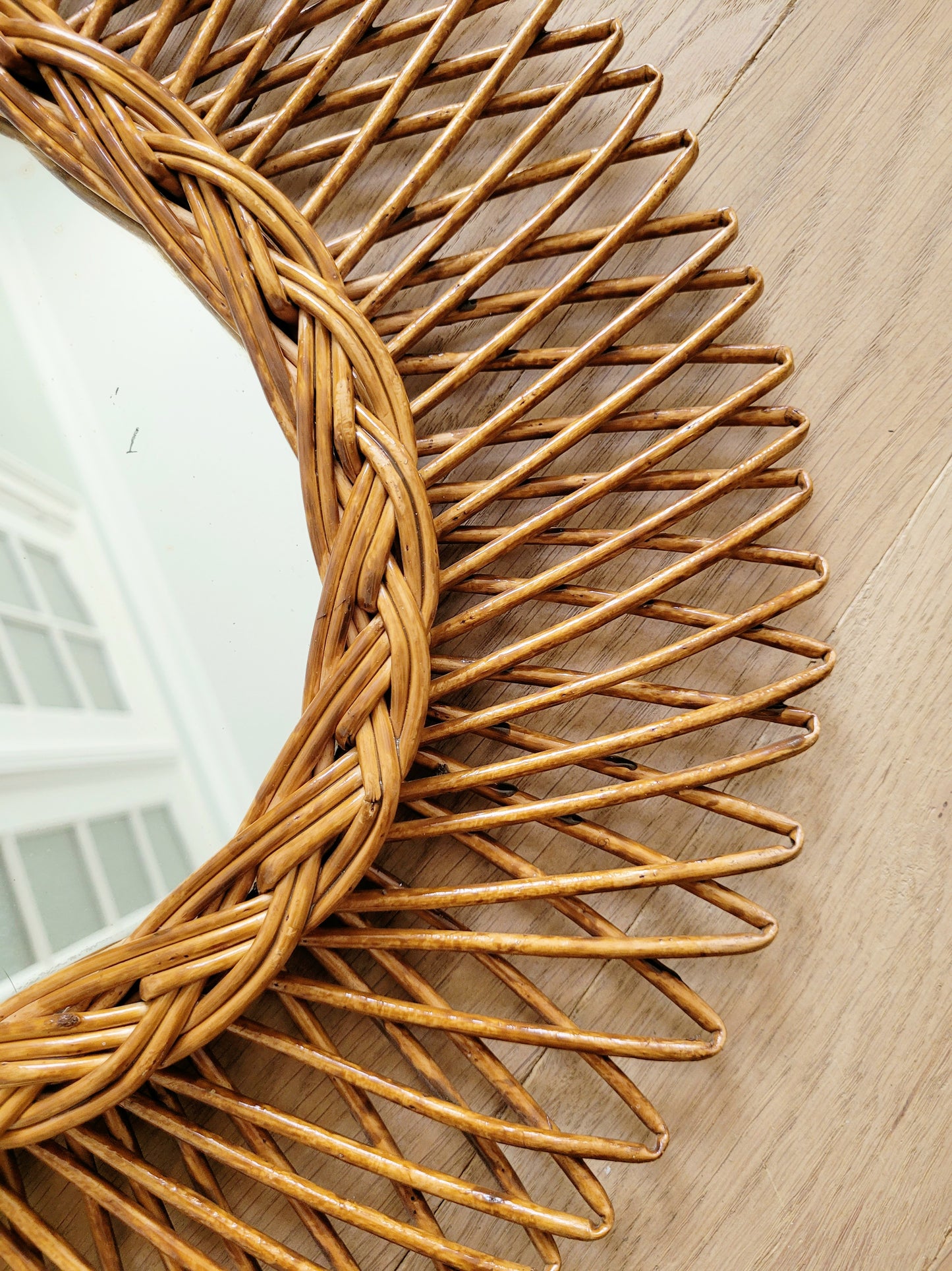 detail of an oval wall mirror in wicker texture