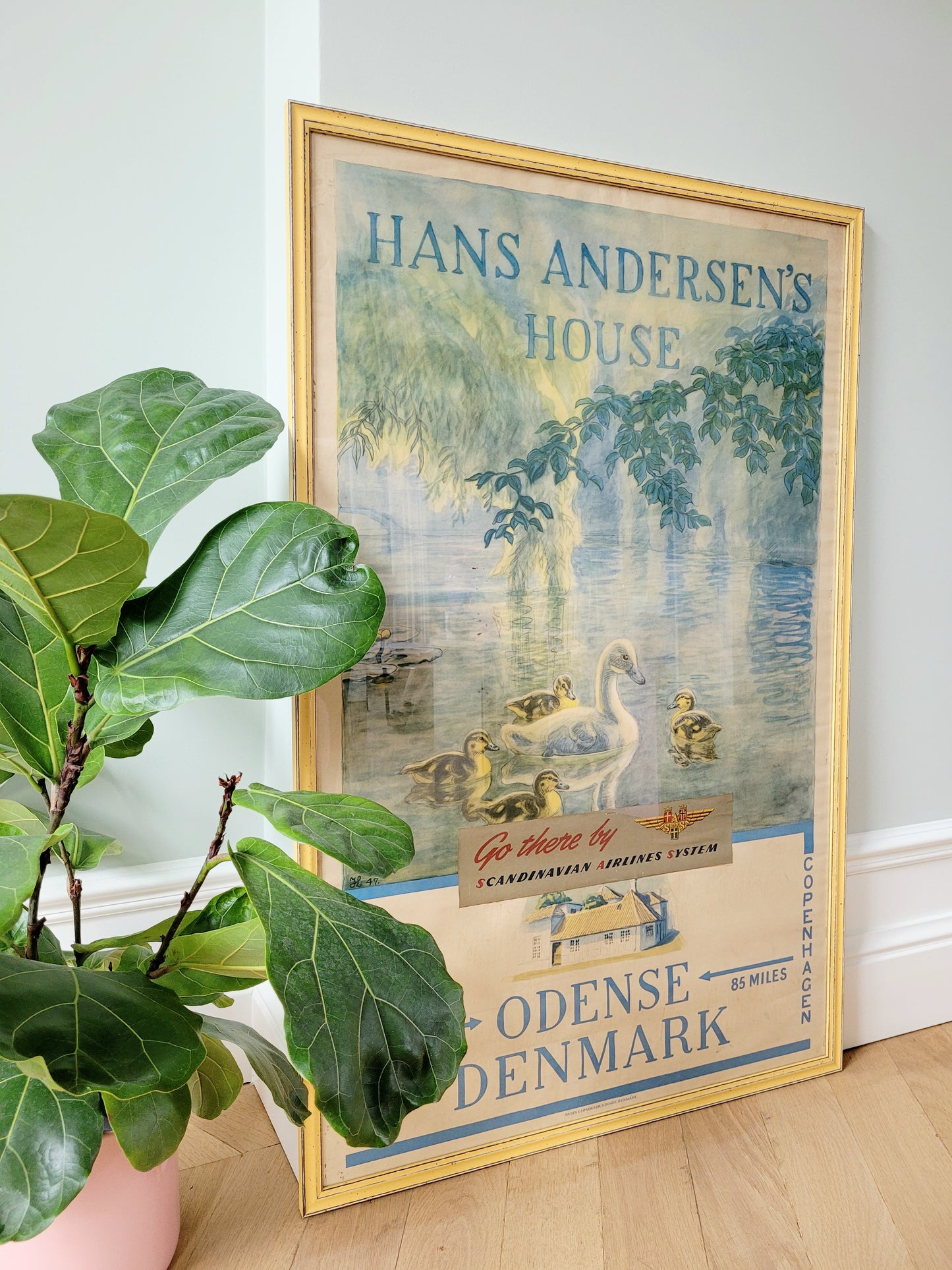 side view of a yellow framed authentic original vintage travel poster for the Hans Christian Andersen's House in Odense Denmark