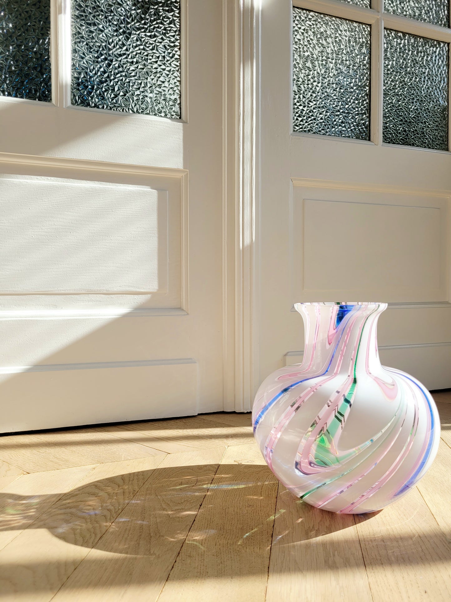 full view of a vintage Michielotto Murano multi swirl vase in a multitude of hues