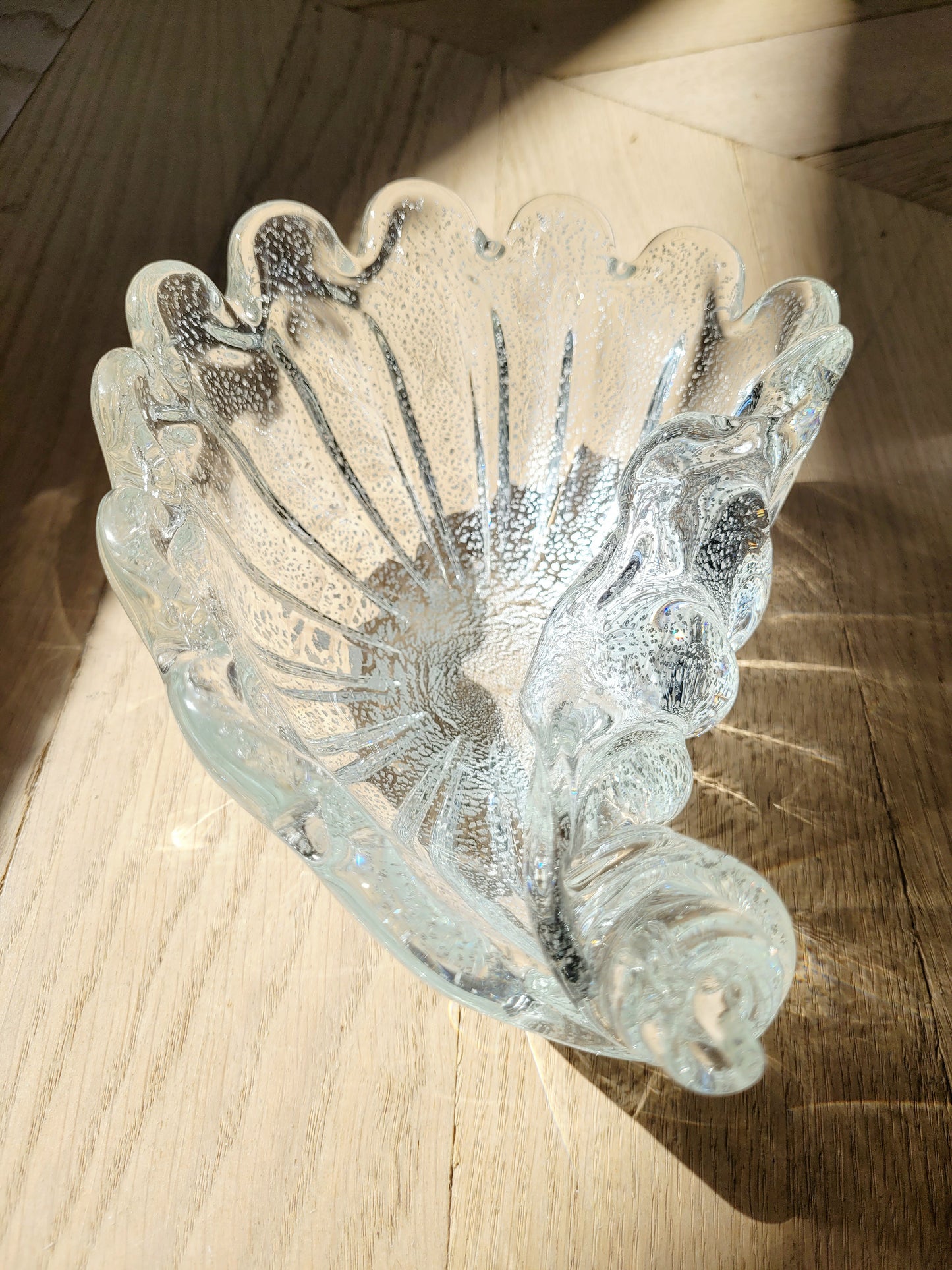 top view of a vintage clear and silver Murano bowl in shell shape