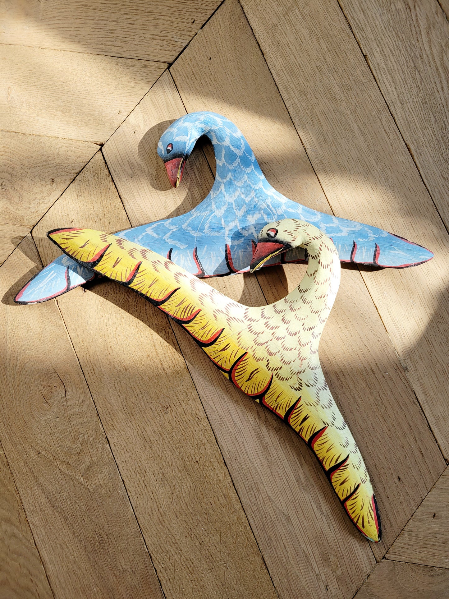 top view of two playful wooden hangers in a bird shape