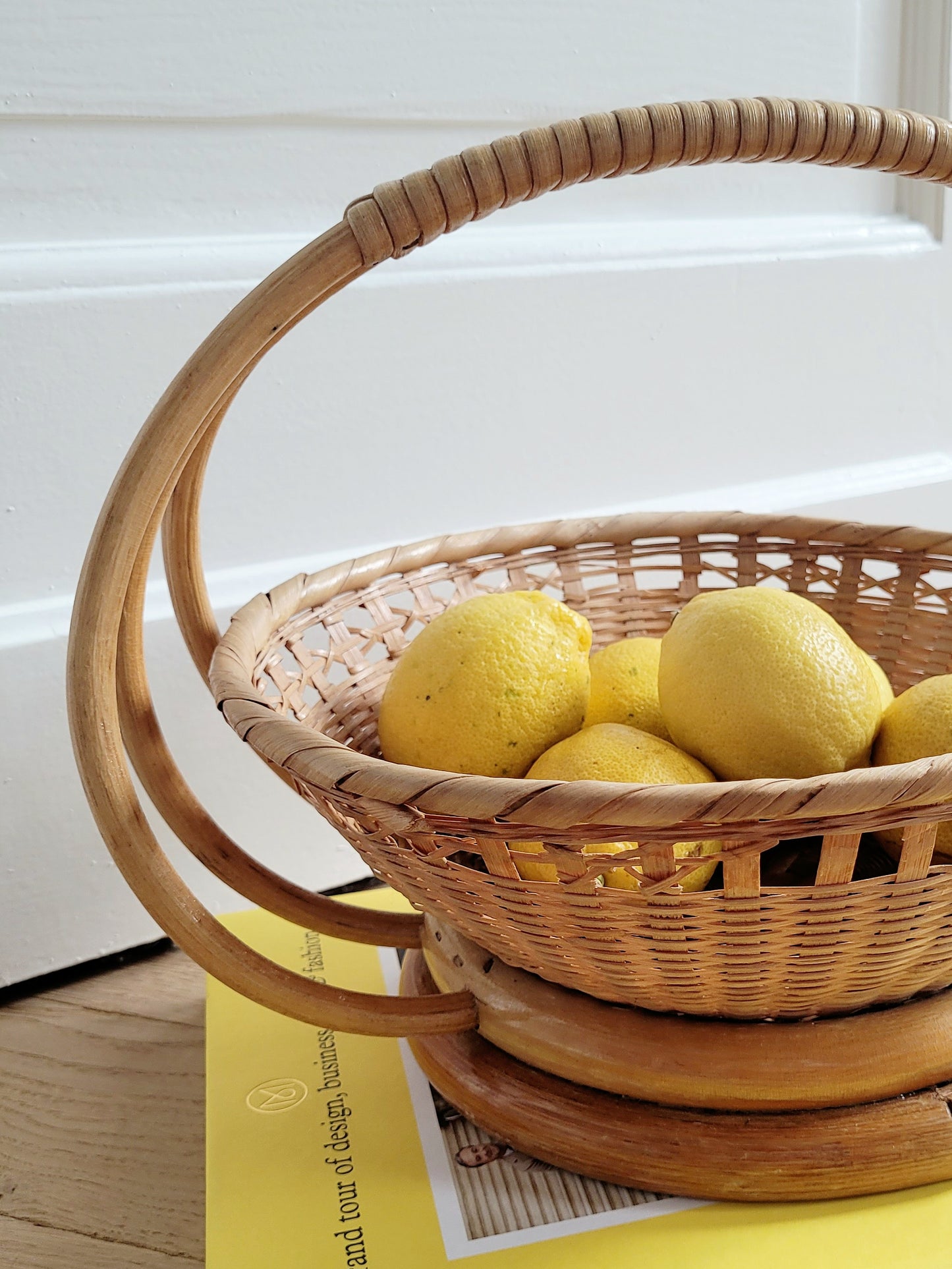 detail of a wicker and rattan fruit basket filled with lemons