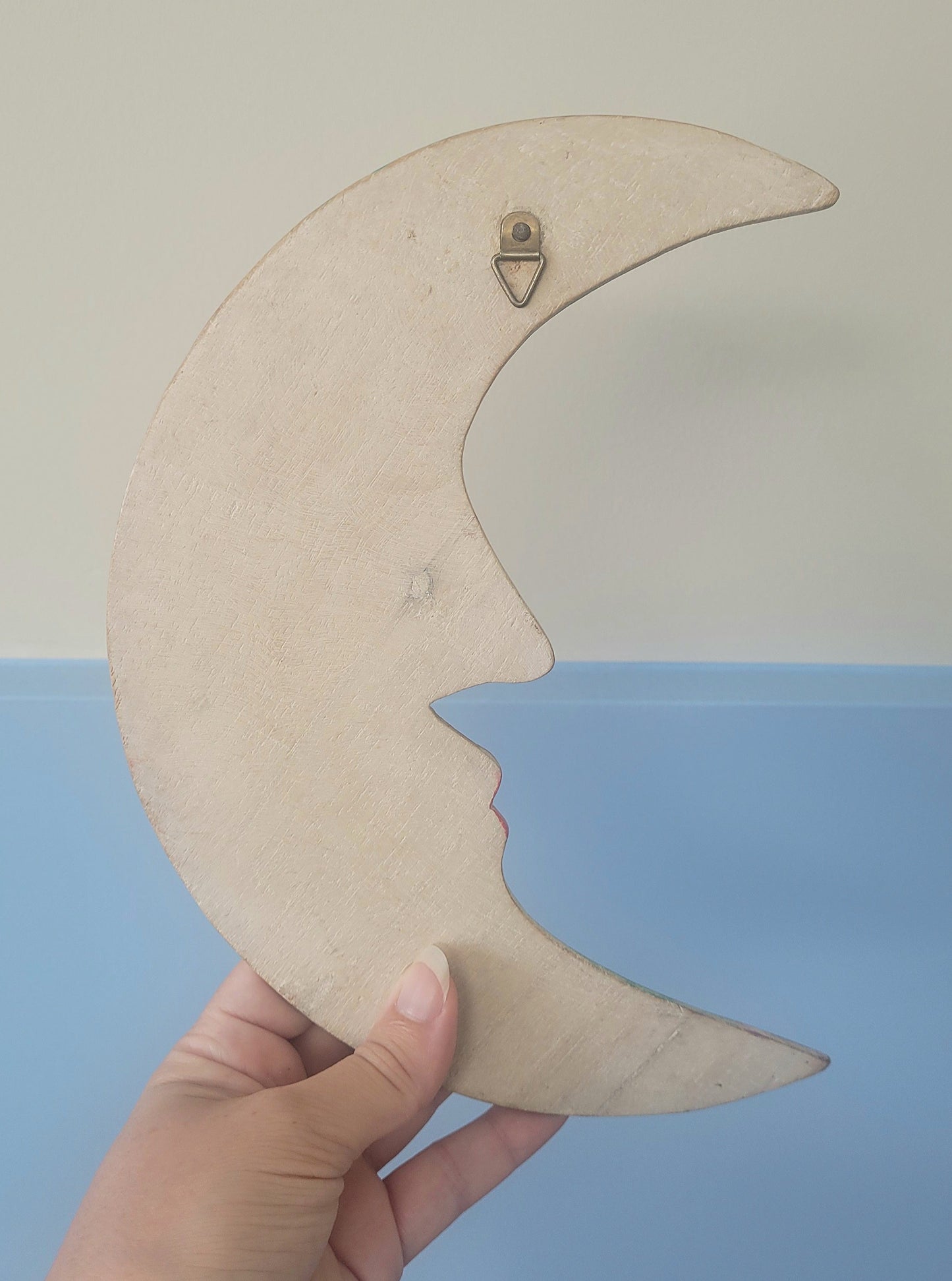 rear view of a carved crescent moon to hang in a children's room