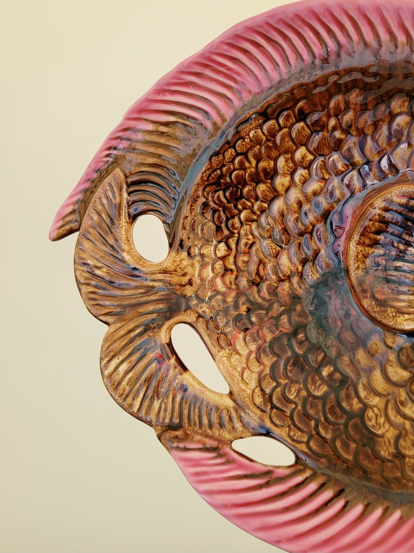 detail of a quirky ceramic serving bowl in fish shape in purple pink and brown