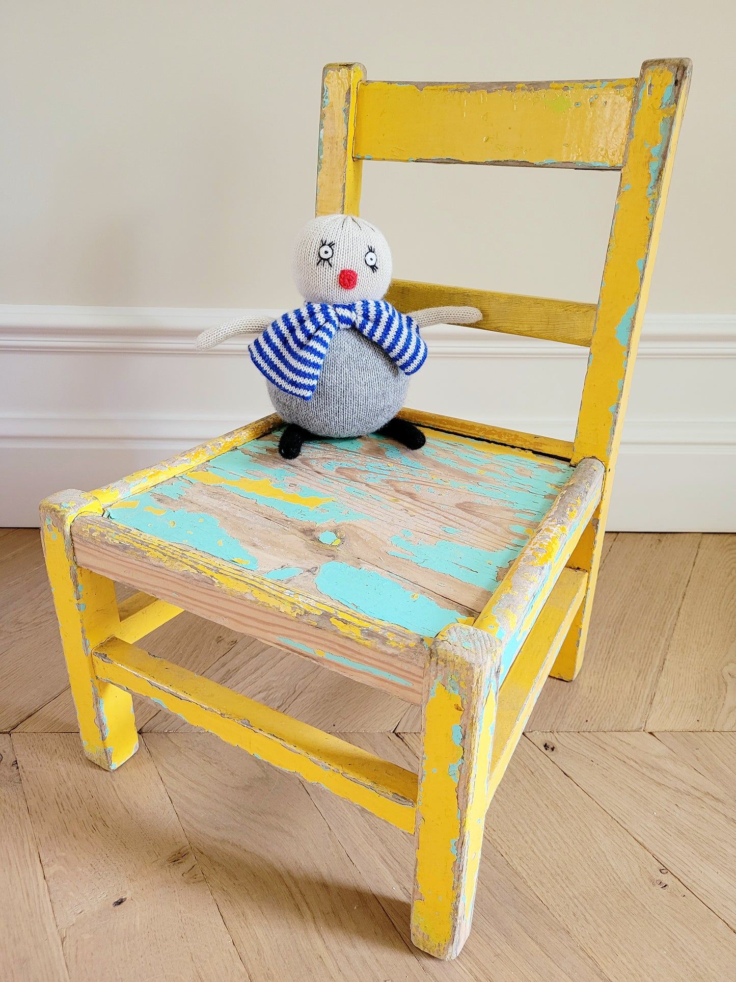 full view of a characterful wooden kids chair in yellow and green with patina