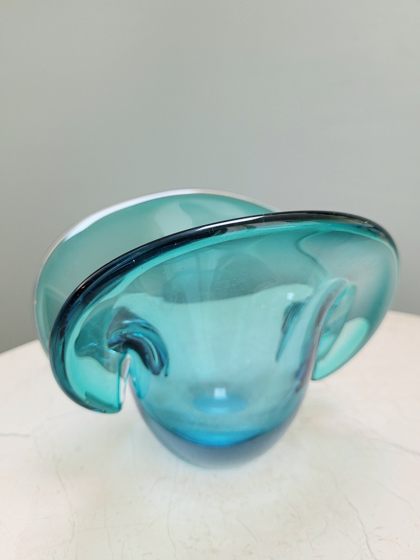 side view of a vintage Murano clam bowl in blue
