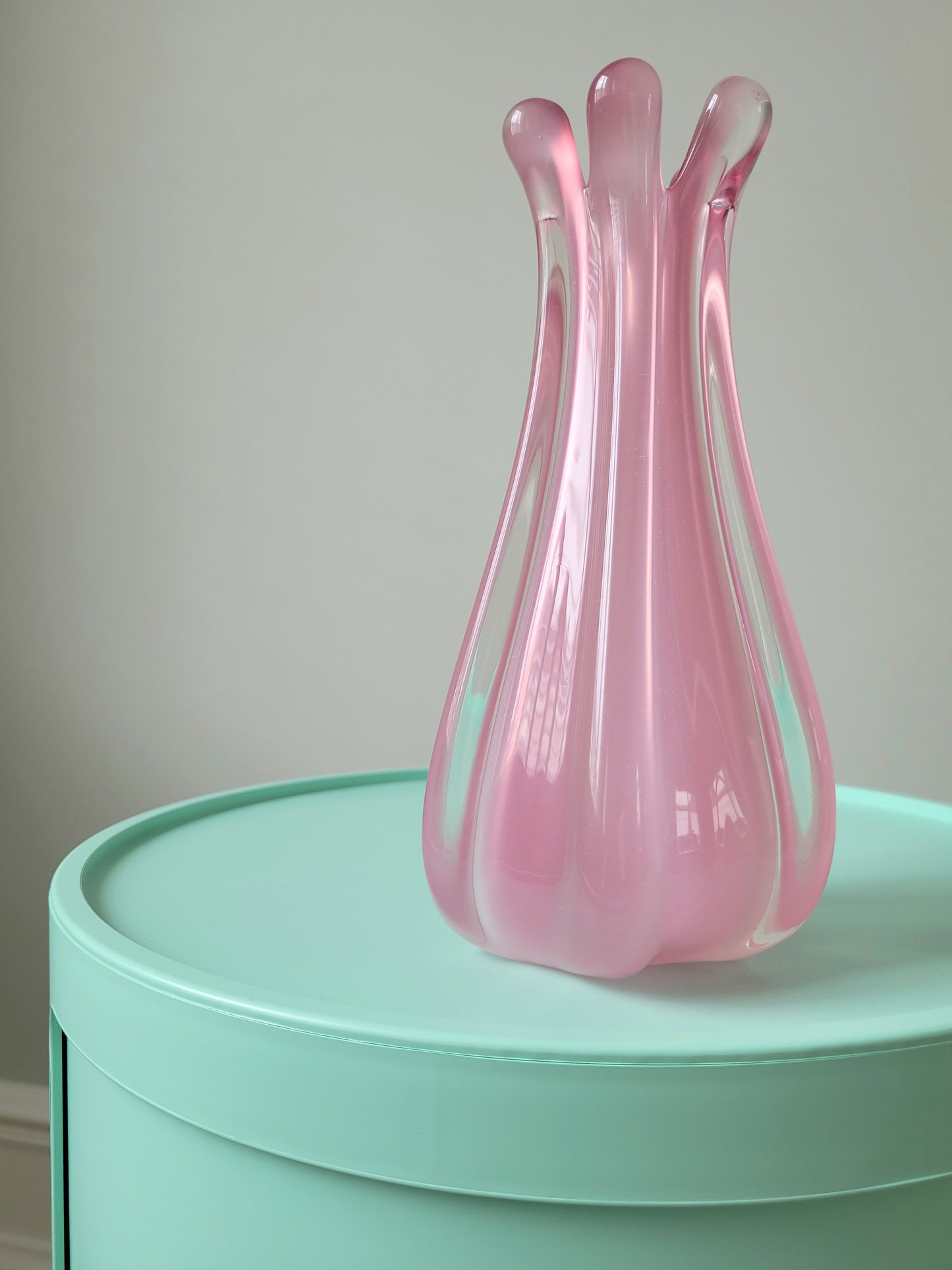 full view of a unique vintage Murano pink hue alabaster vase on a mint green side table