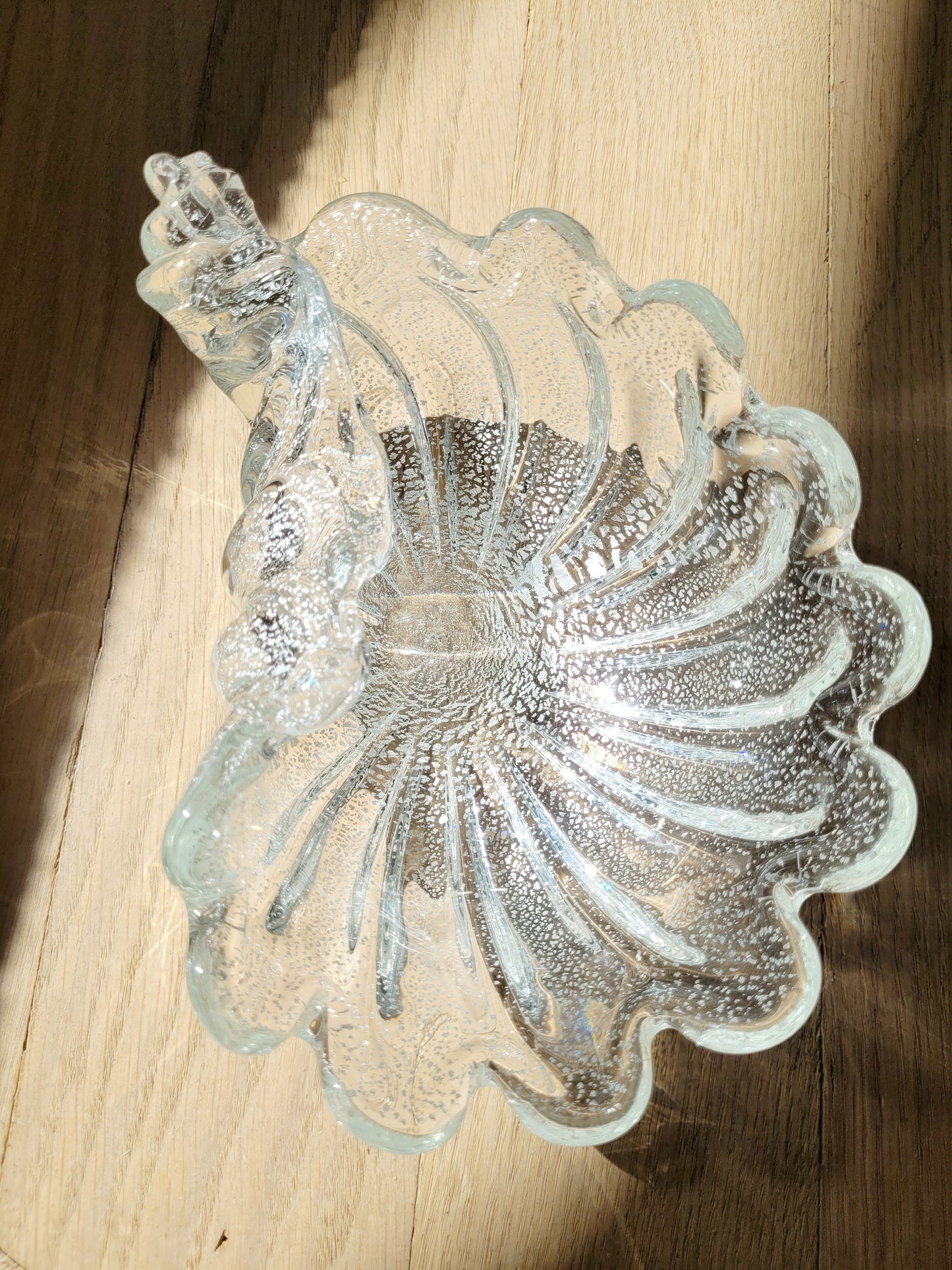 top view of a vintage clear and silver Murano bowl in shell shape