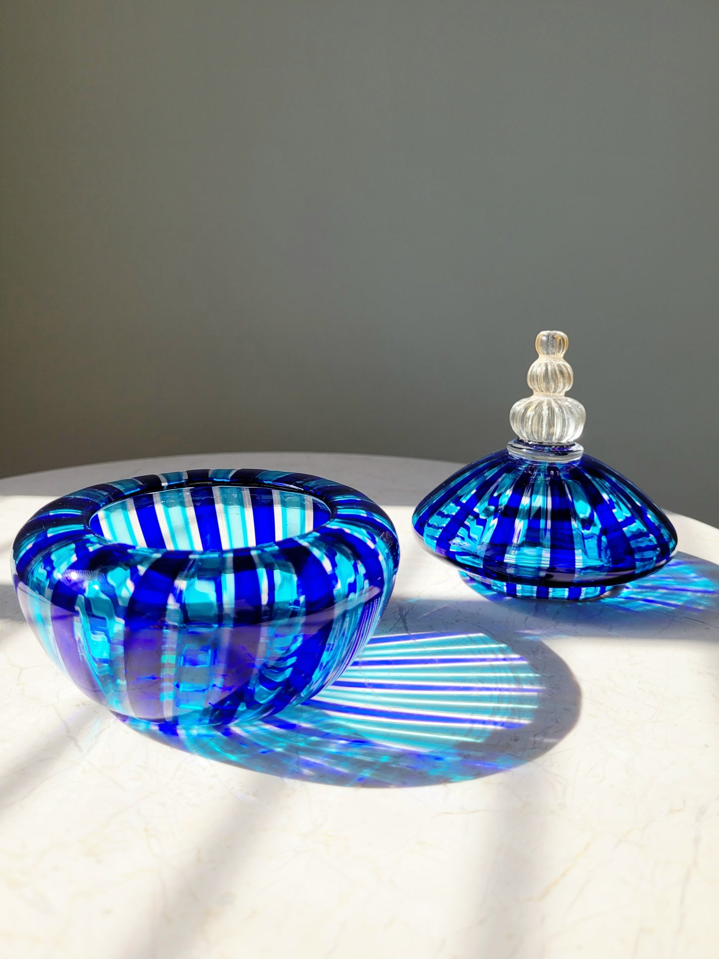 detail of a handcrafted vintage striped Murano bonbonniere in blue and gold