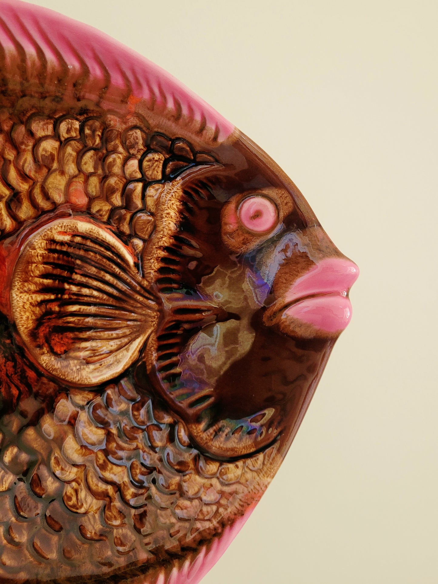 detail of a quirky ceramic serving bowl in fish shape in purple pink and brown