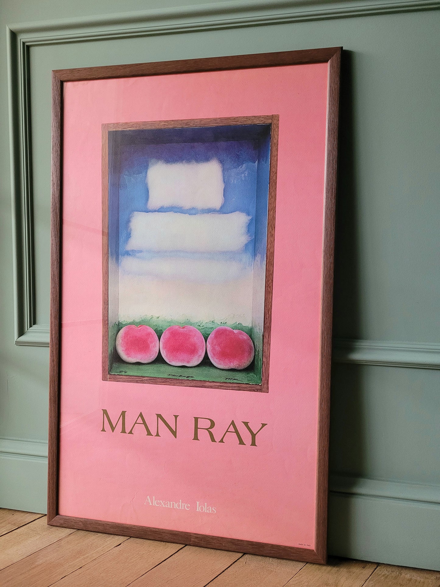 side view of an authentic original exhibition poster from the Man Ray exhibition at the Alexandre Iolas Gallery, depicting his "Three peaches"-work