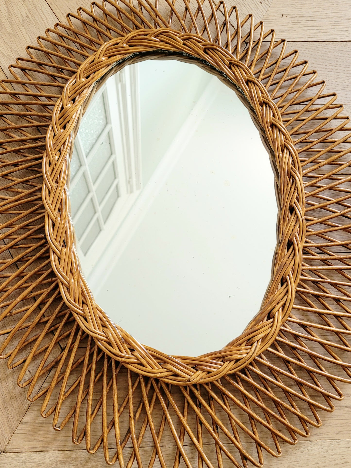 top view of an oval wall mirror in wicker texture