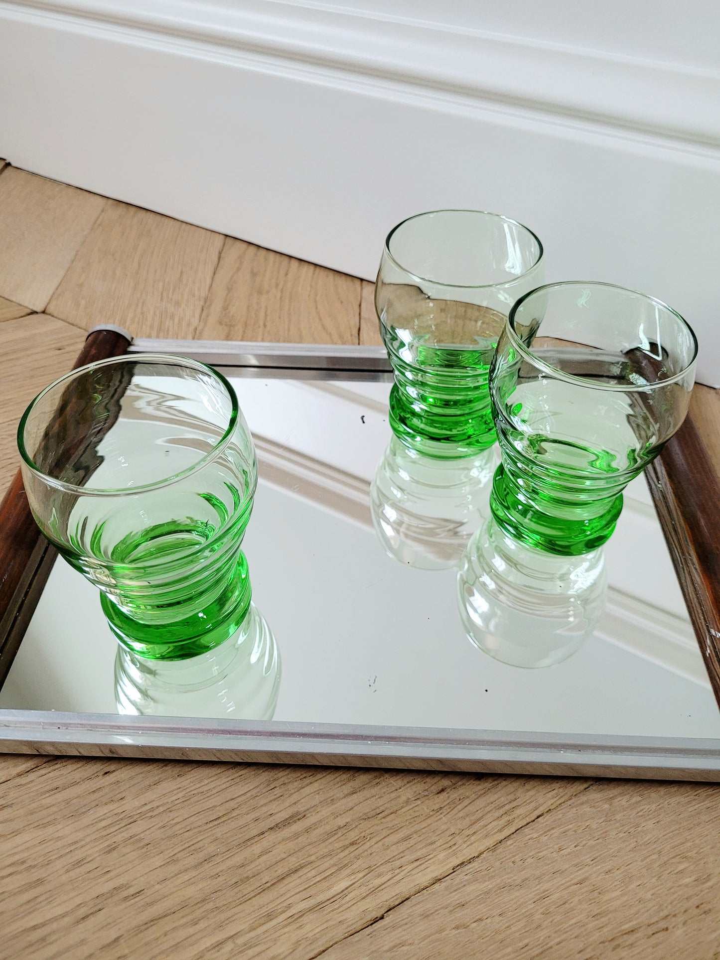 top view of bright green art deco drinking glasses on a mirror tray 6pc