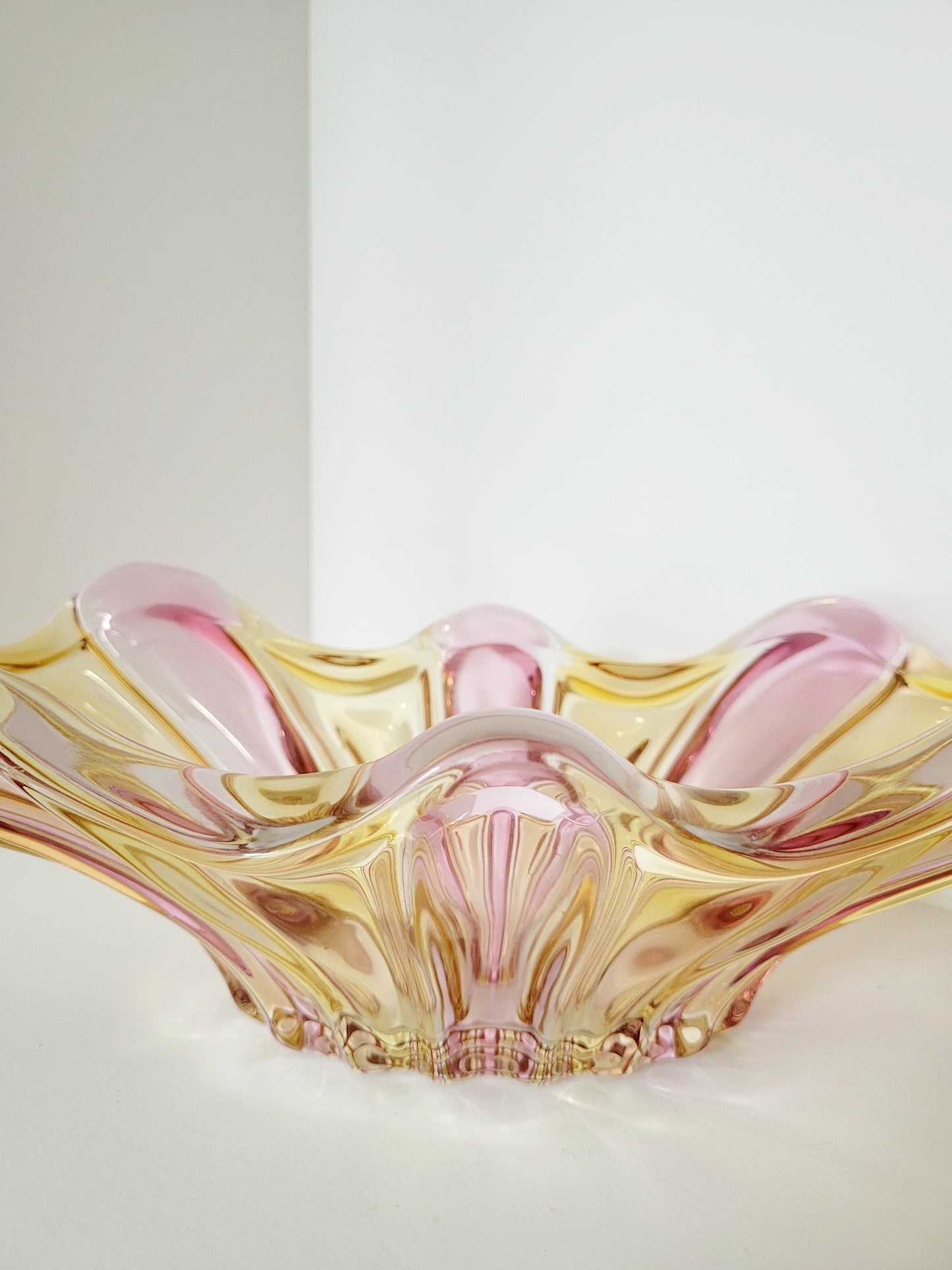 detail of a vibrant candy coloured glass serving or trinket bowl in yellow and pink