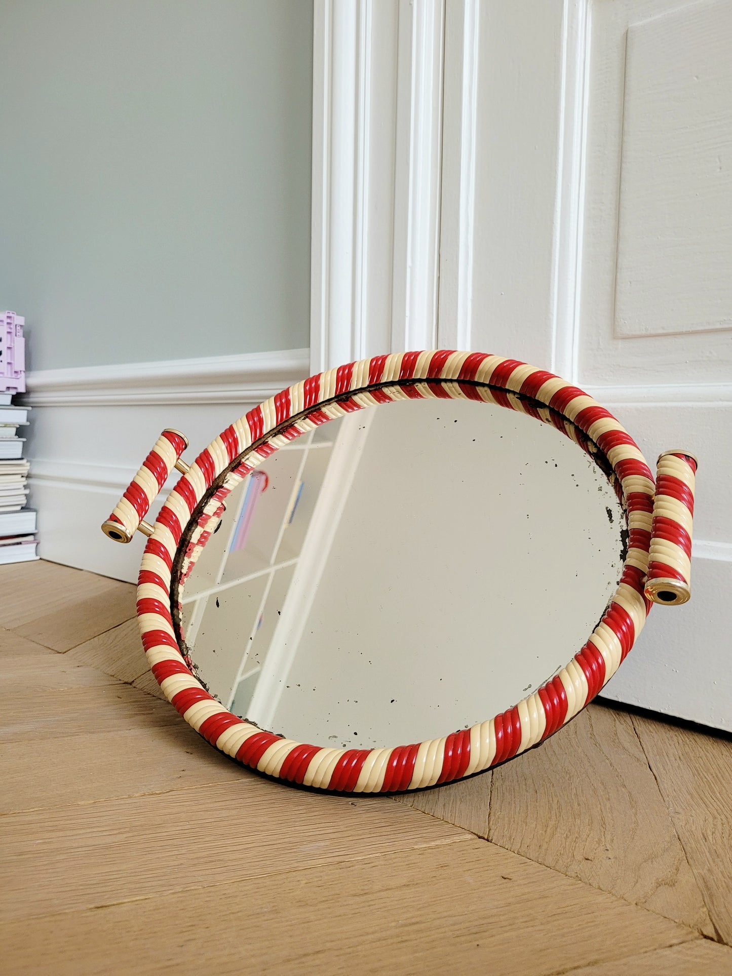 front view of a vintage mirror tray featuring a candy cane stripe design
