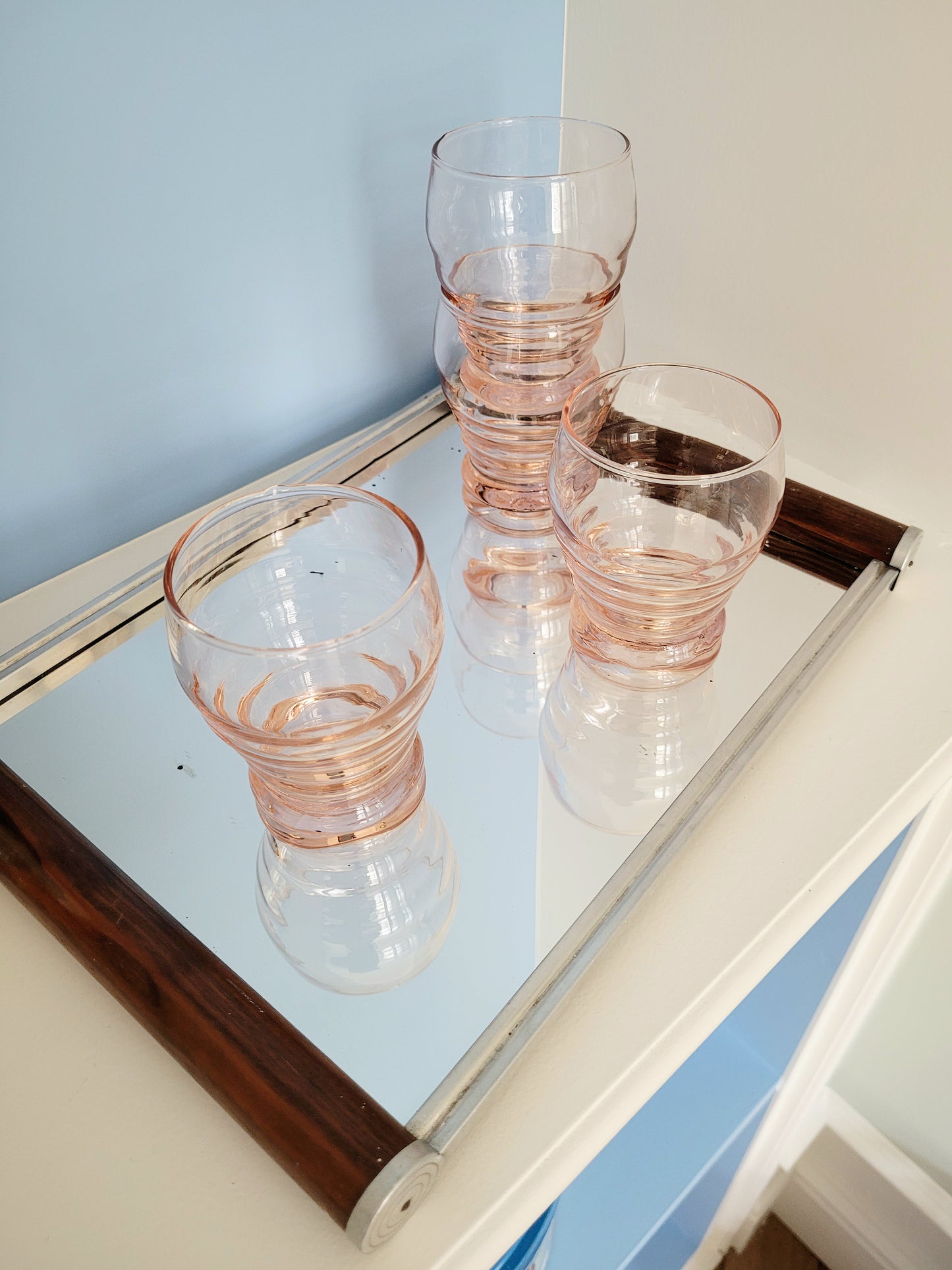 top view of coral art deco drinking glasses 6pc on a mirror tray