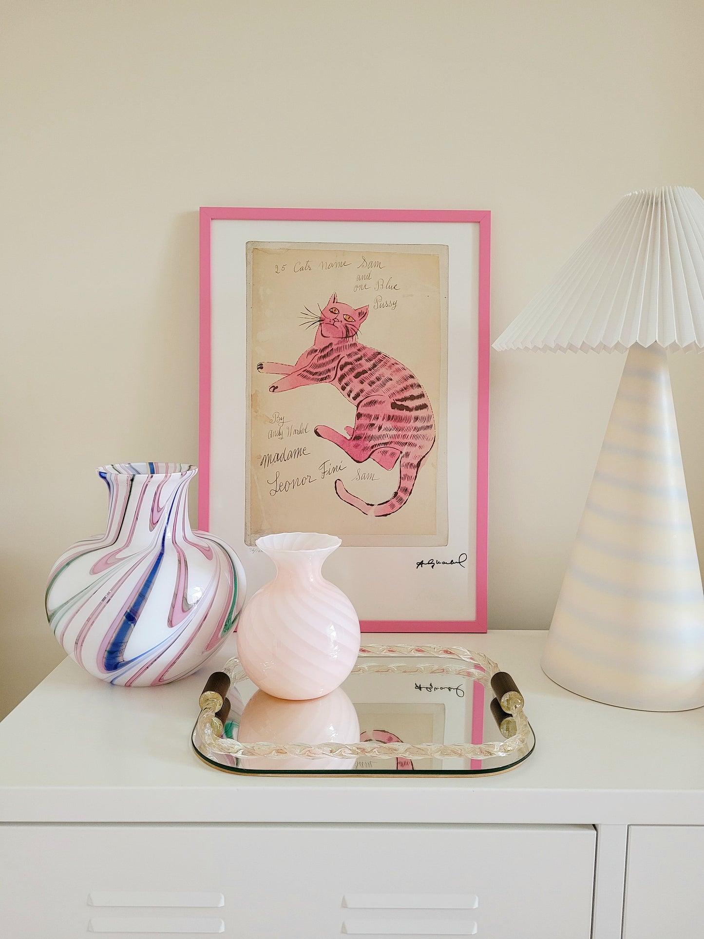 front view of the lithograph cat Sam by Andy Warholl in a pink frame