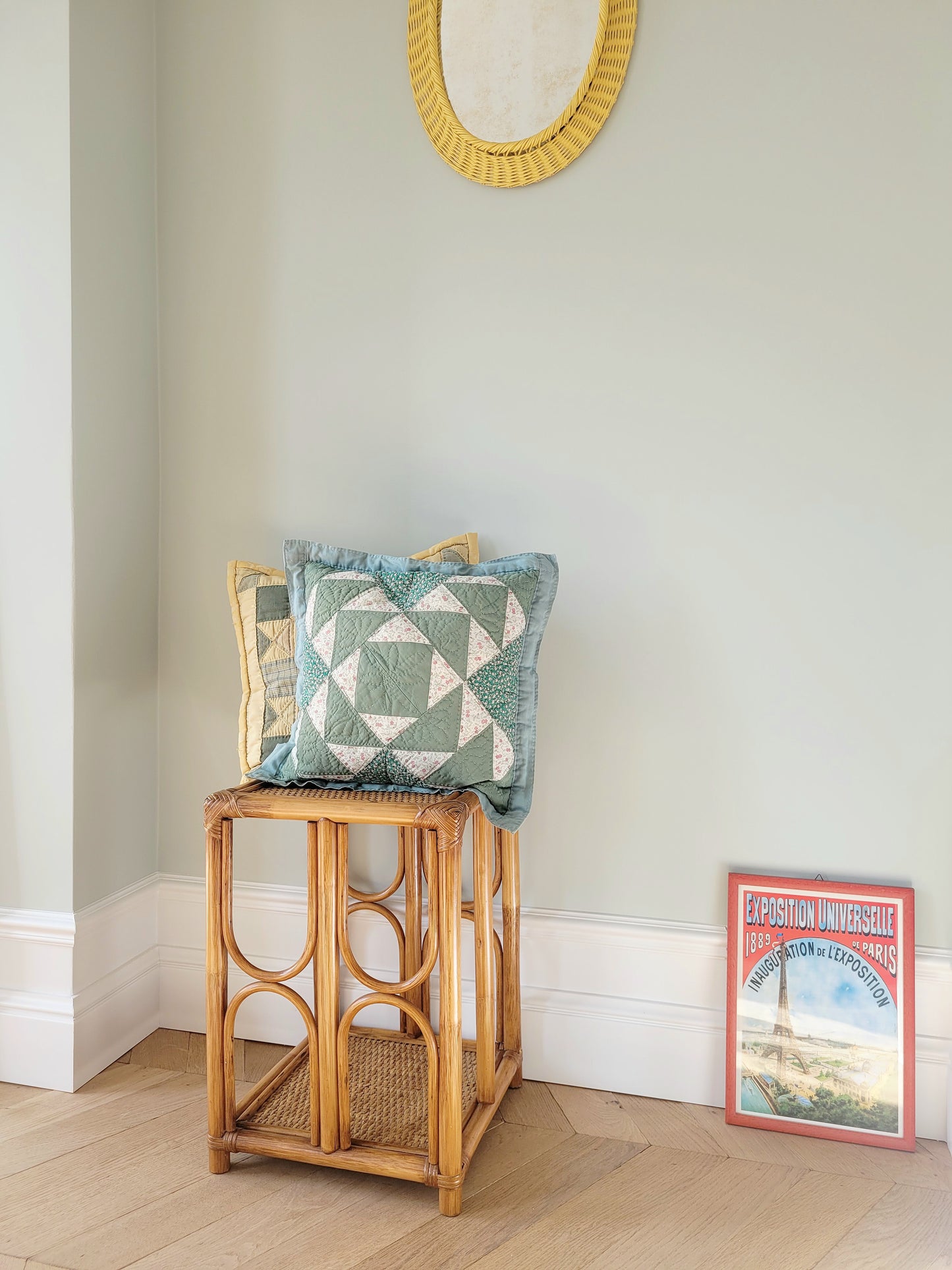 full view of quilted cushions in green and yellow hues and pattern on a bamboo side table