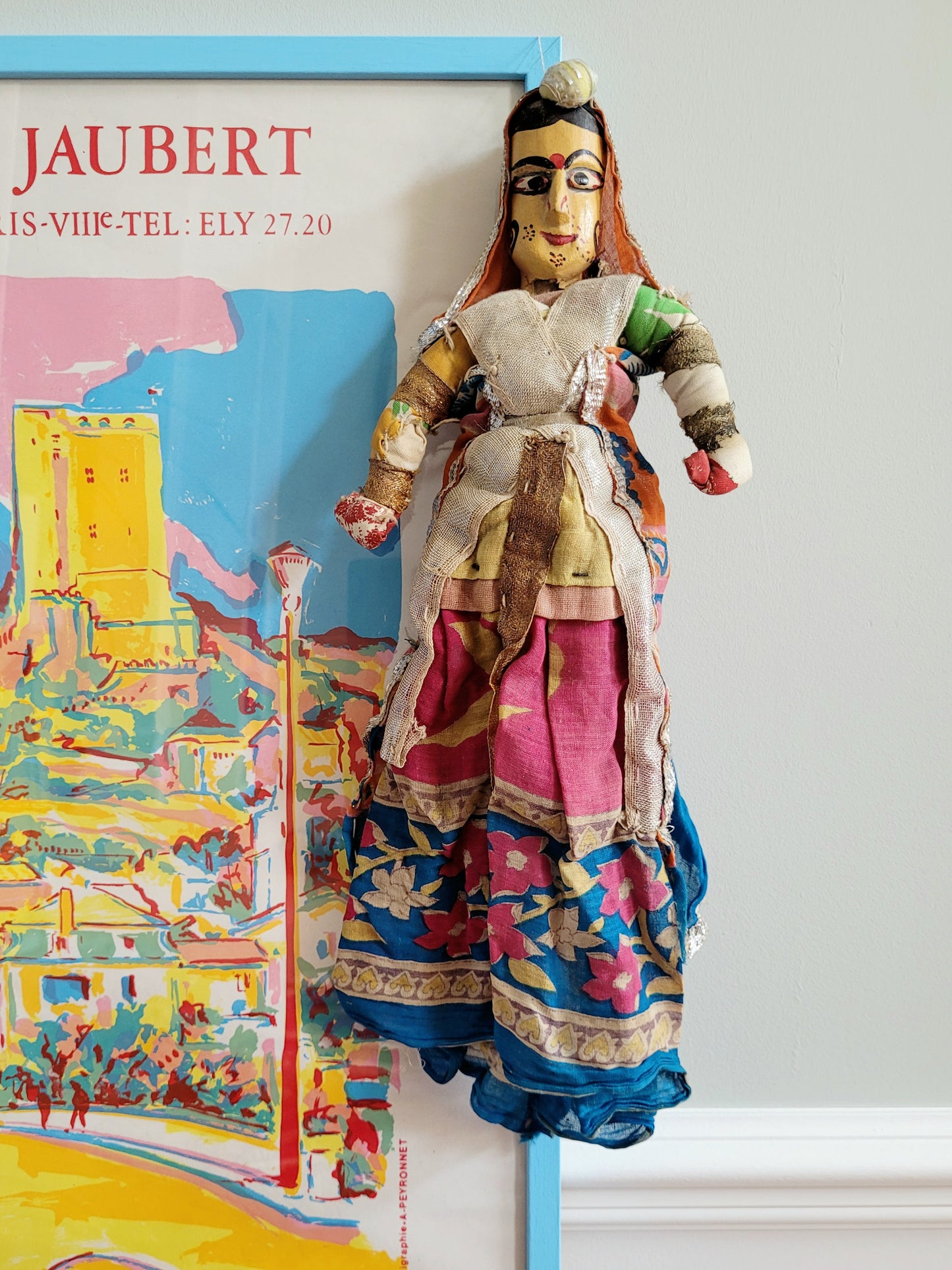 a vintage Asian textile puppet doll in vibrant colours
