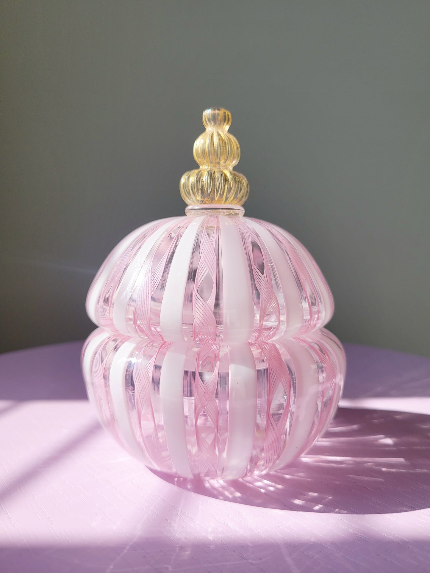 front view of a handcrafted vintage striped Murano bonbonniere in pink white and gold
