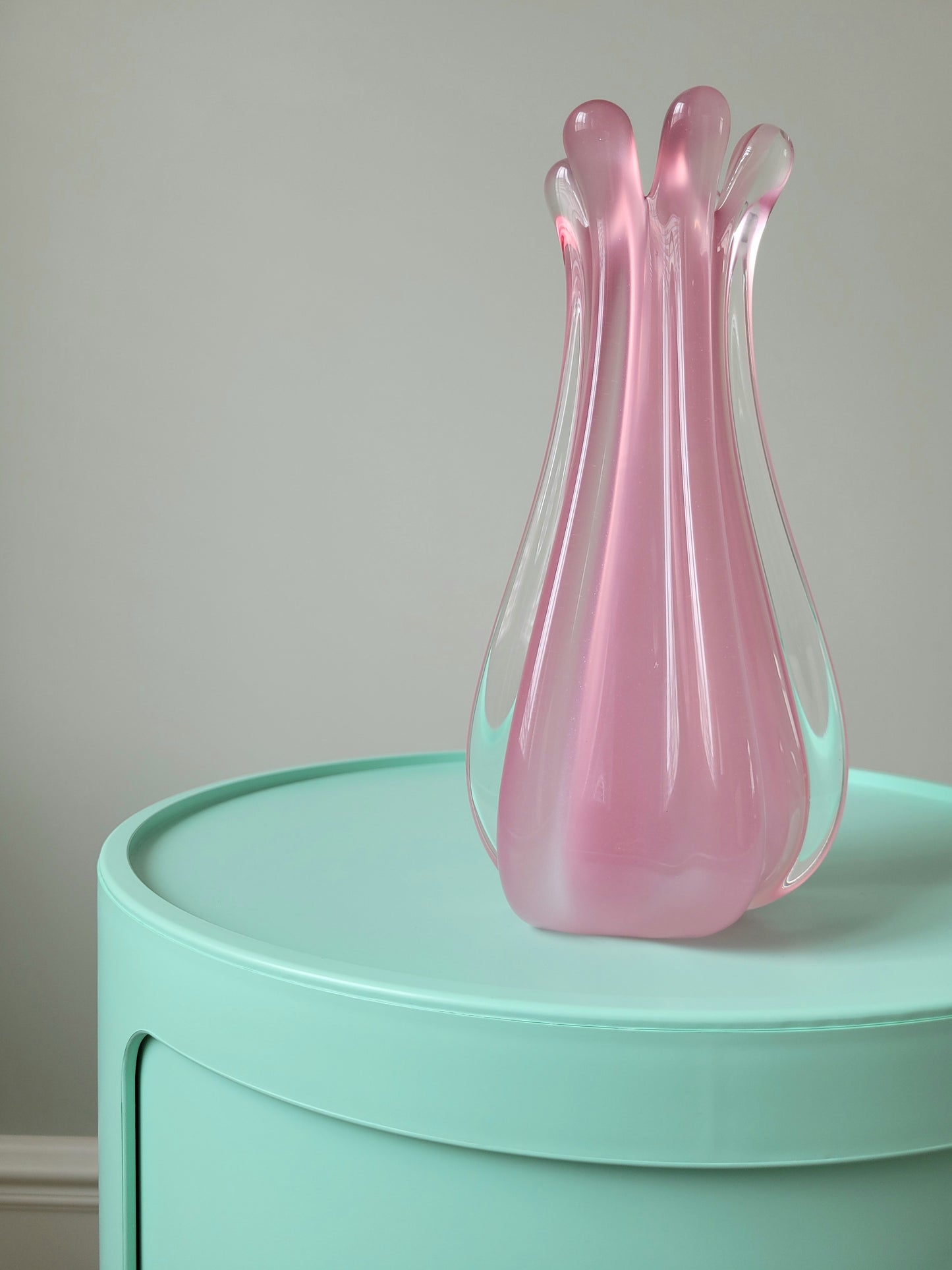 full view of a unique vintage Murano pink hue alabaster vase on a mint green side table