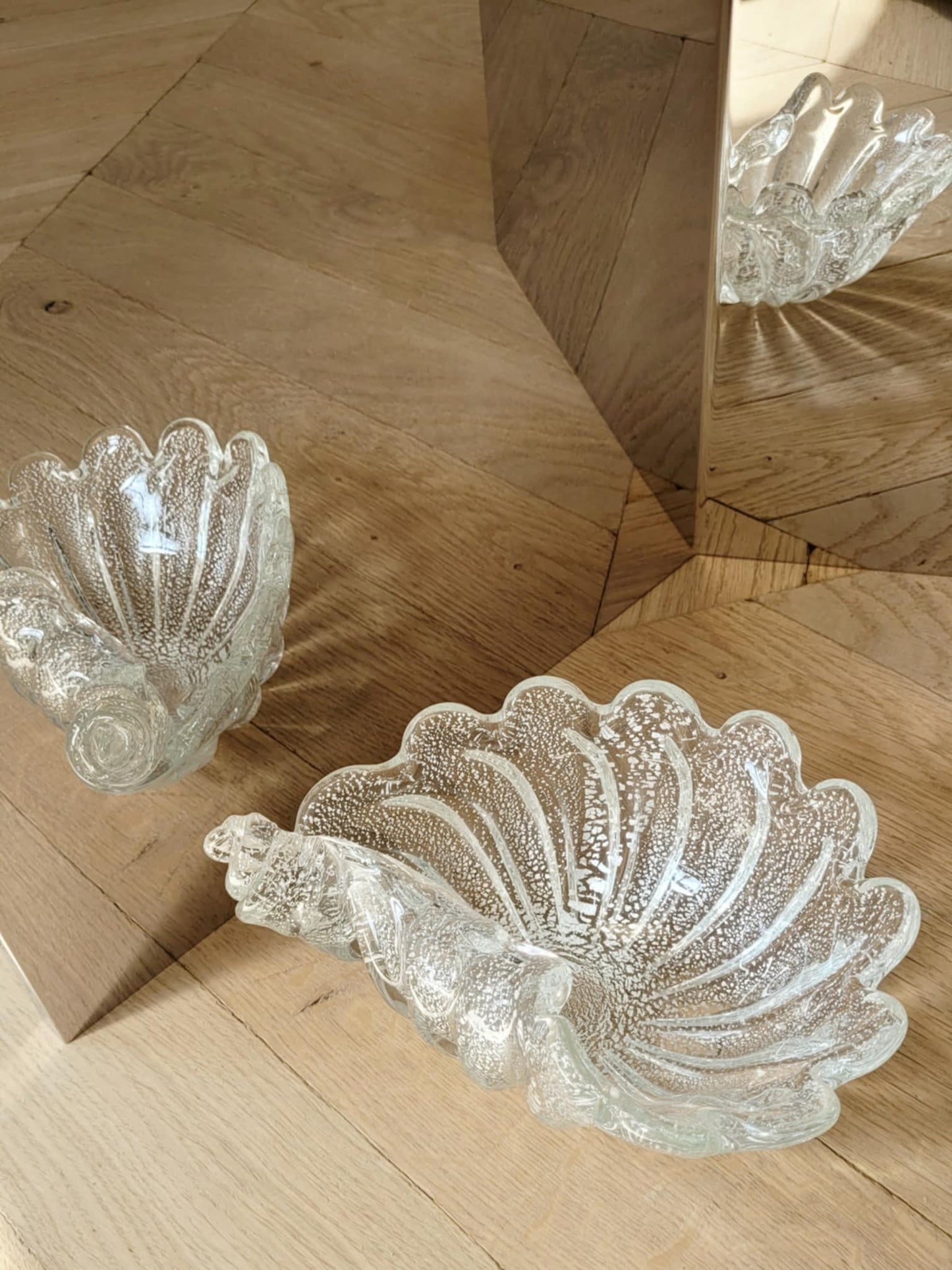 full view of a vintage clear and silver Murano bowl in shell shape