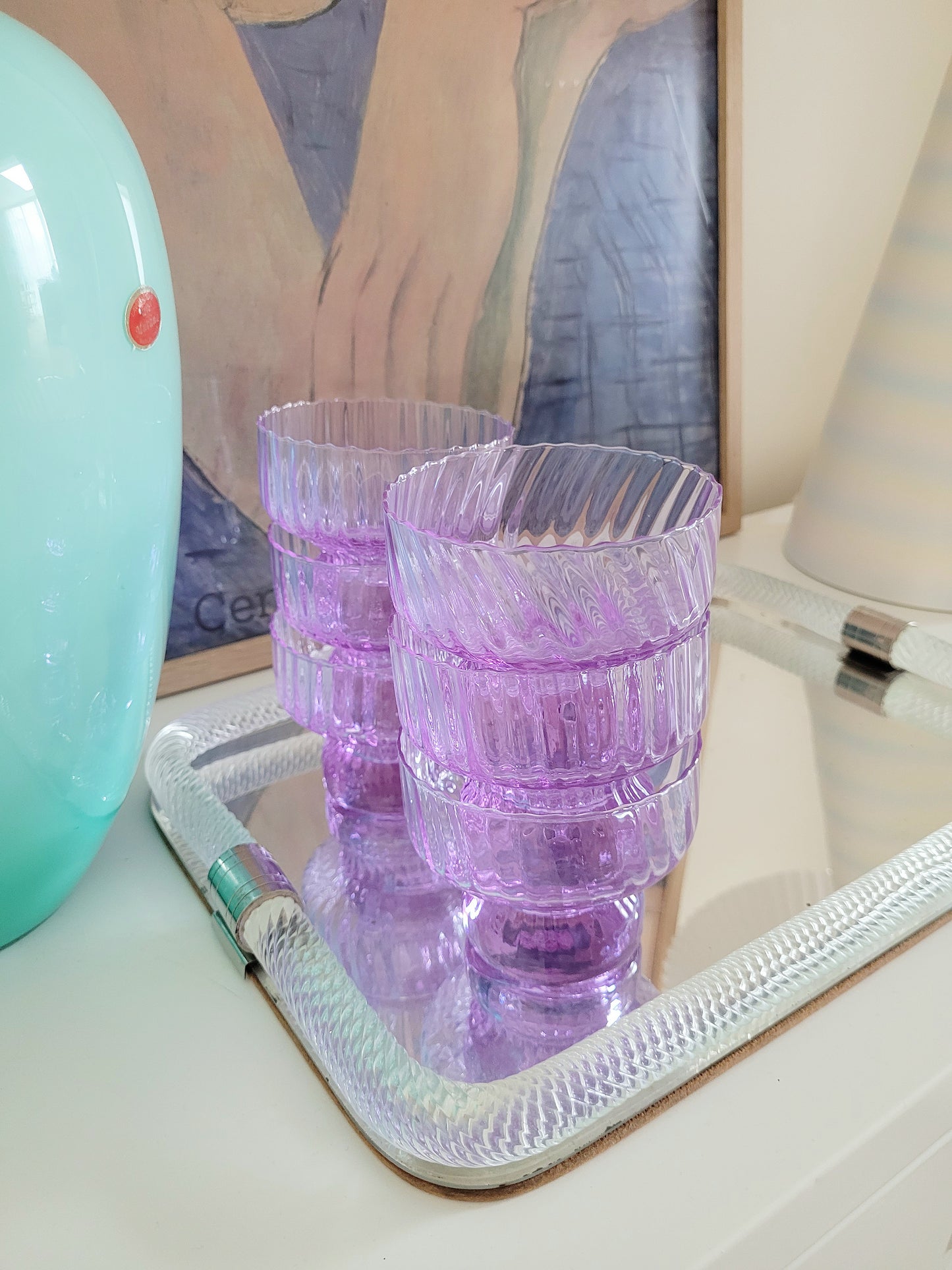 detail of 6 purple Italian glasses and cups on a vintage Murano mirror tray