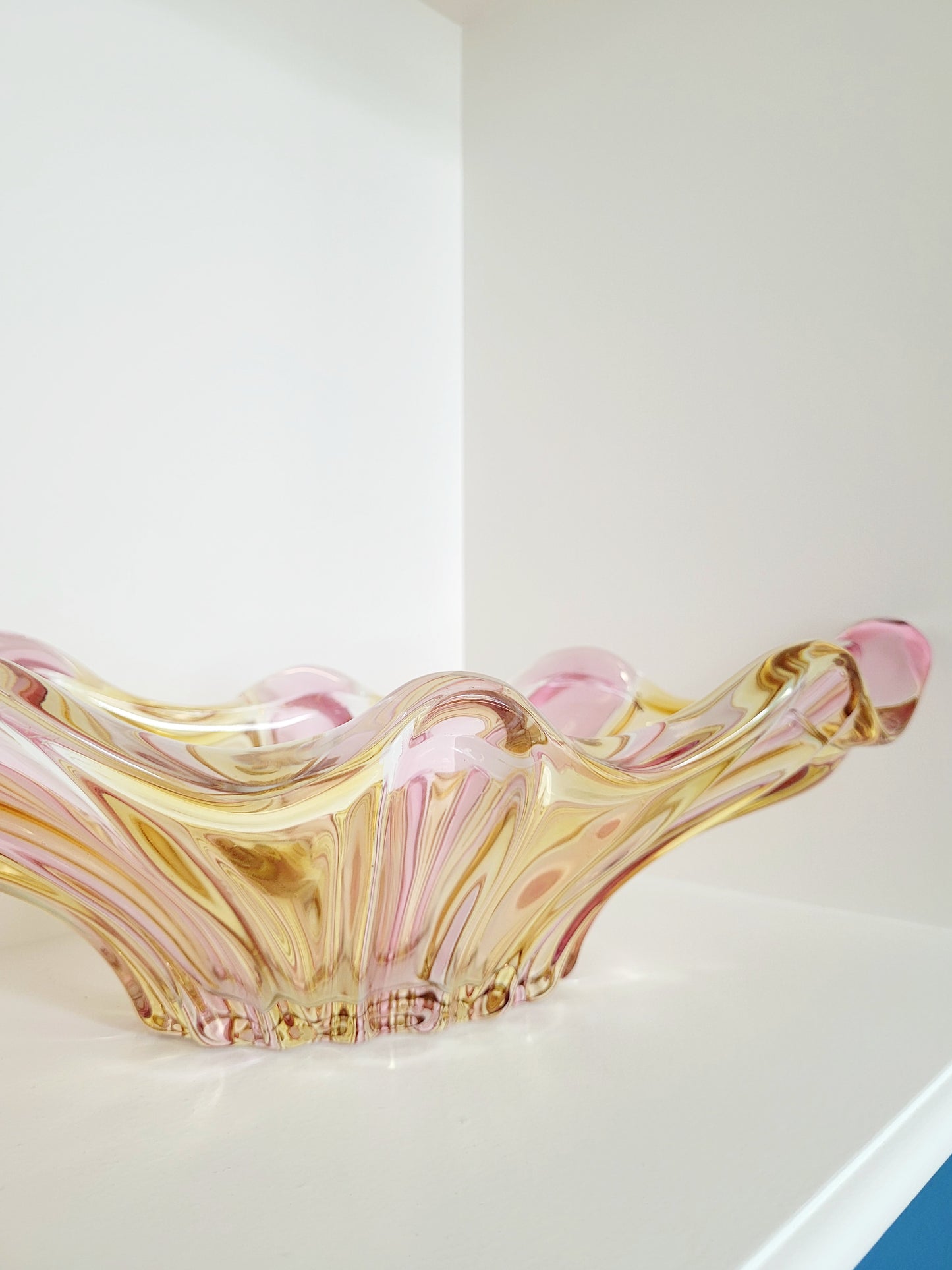 detail of a vibrant candy coloured glass serving or trinket bowl in yellow and pink
