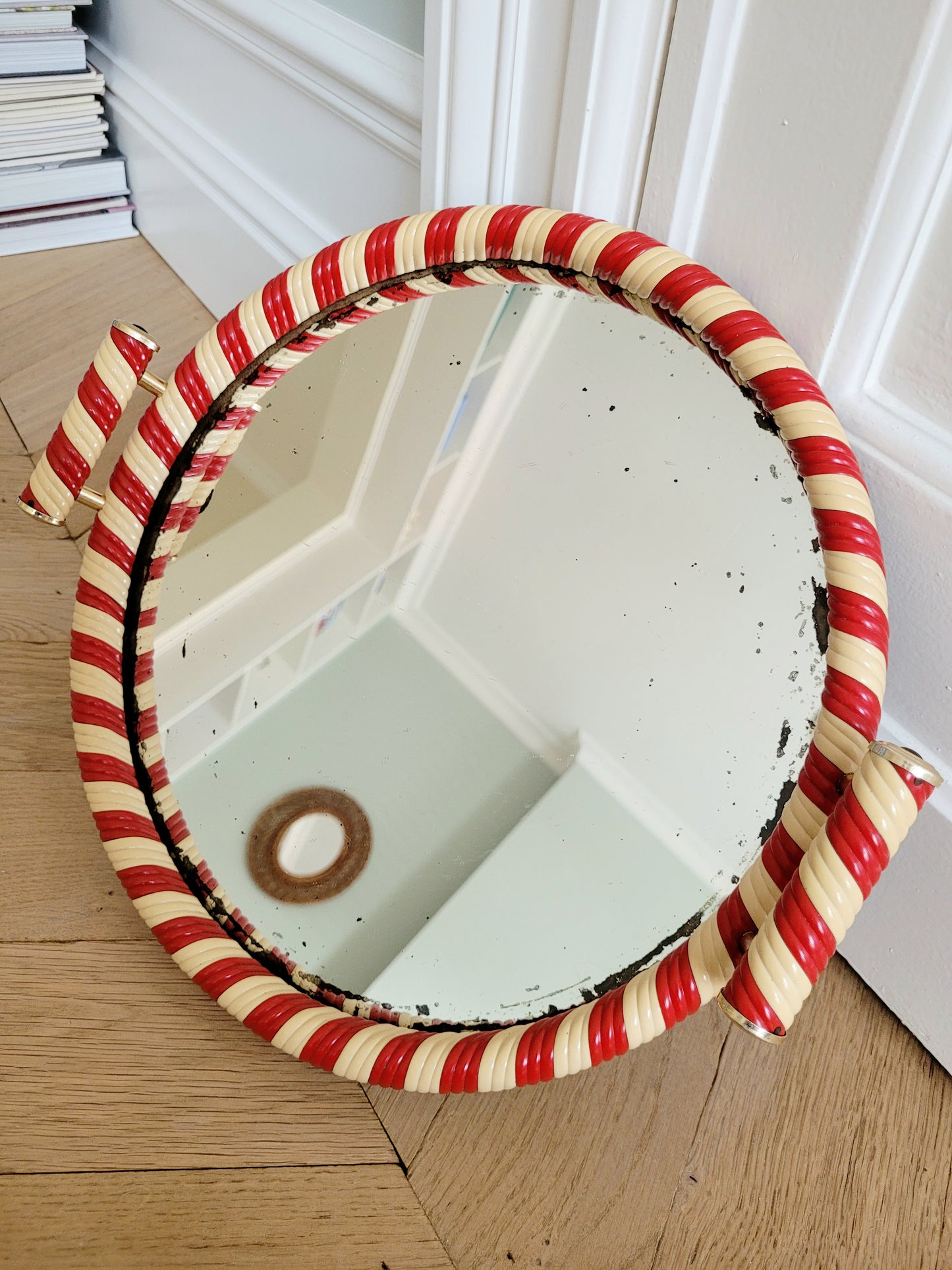 top view of a vintage mirror tray featuring a candy cane stripe design
