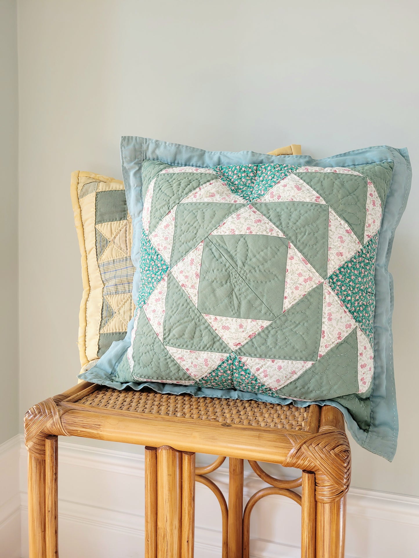 front view of quilted cushions in green and yellow hues and pattern