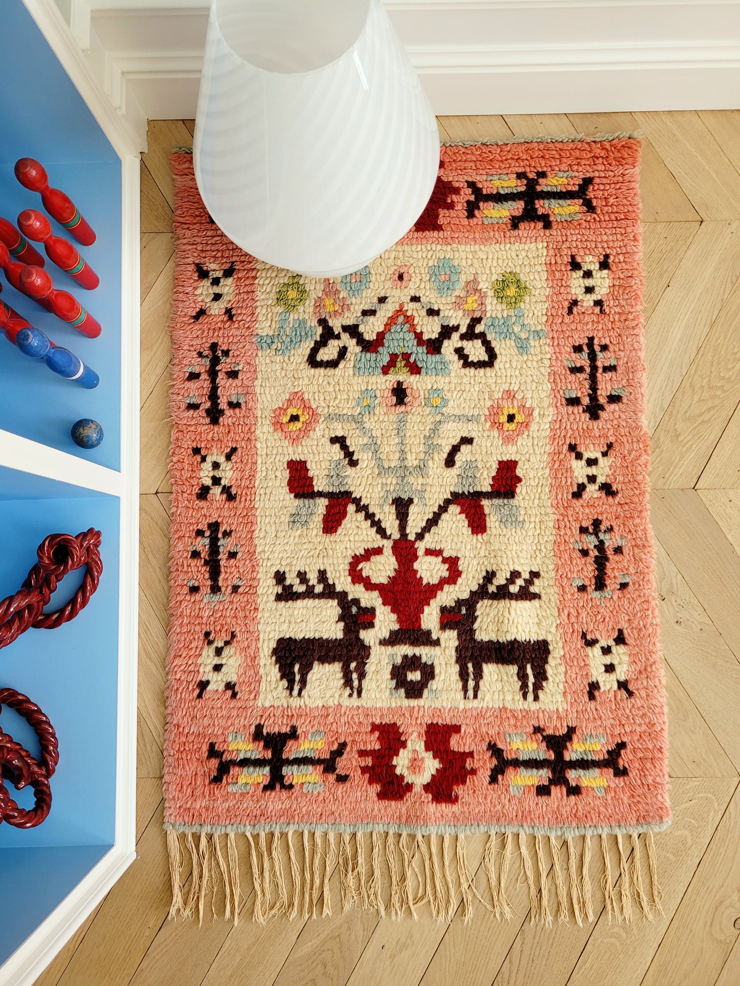 top view of a vintage colourful Scandinavian Rya rug made from wool