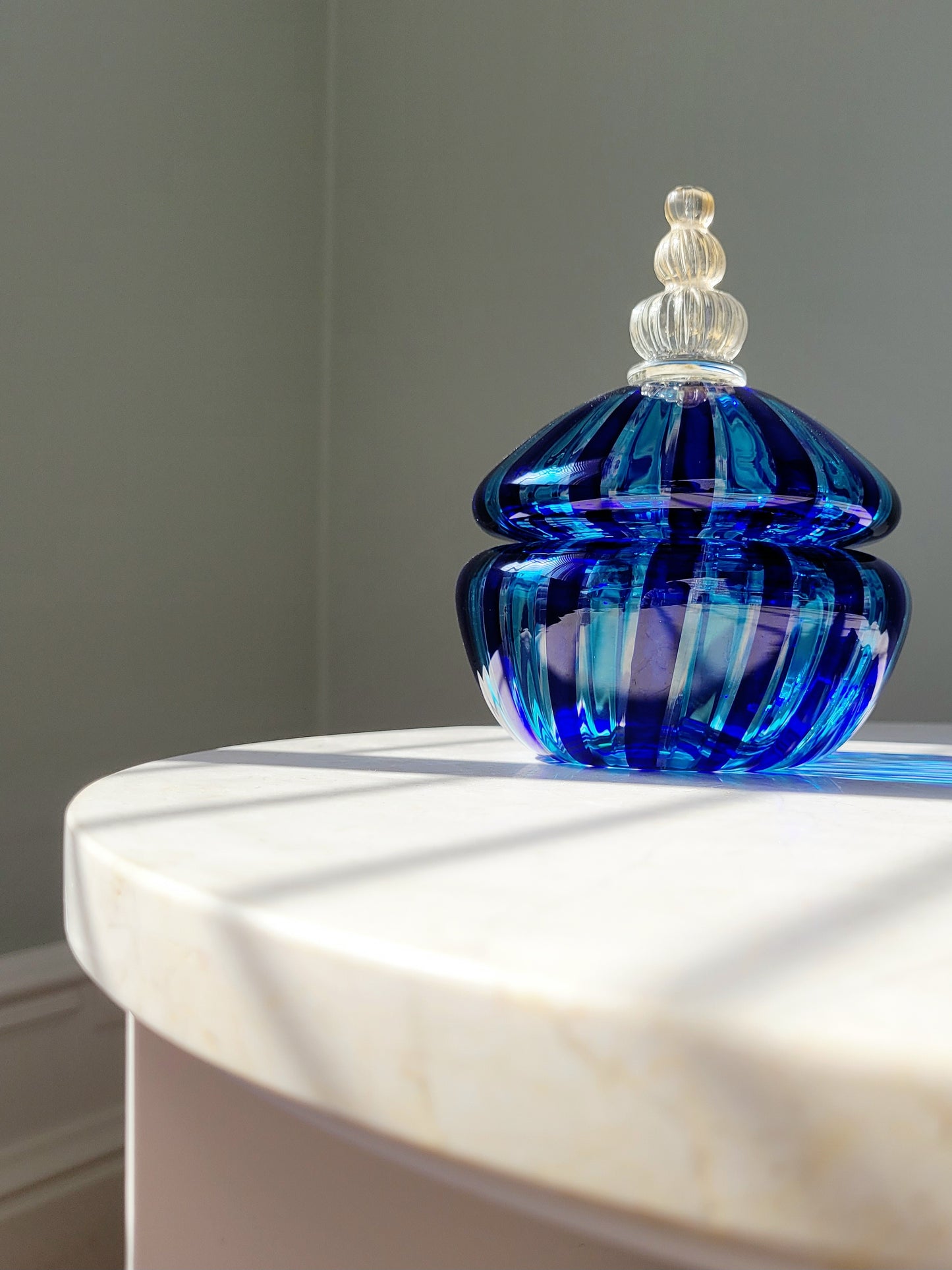 full view of a handcrafted vintage striped Murano bonbonniere in blue and gold