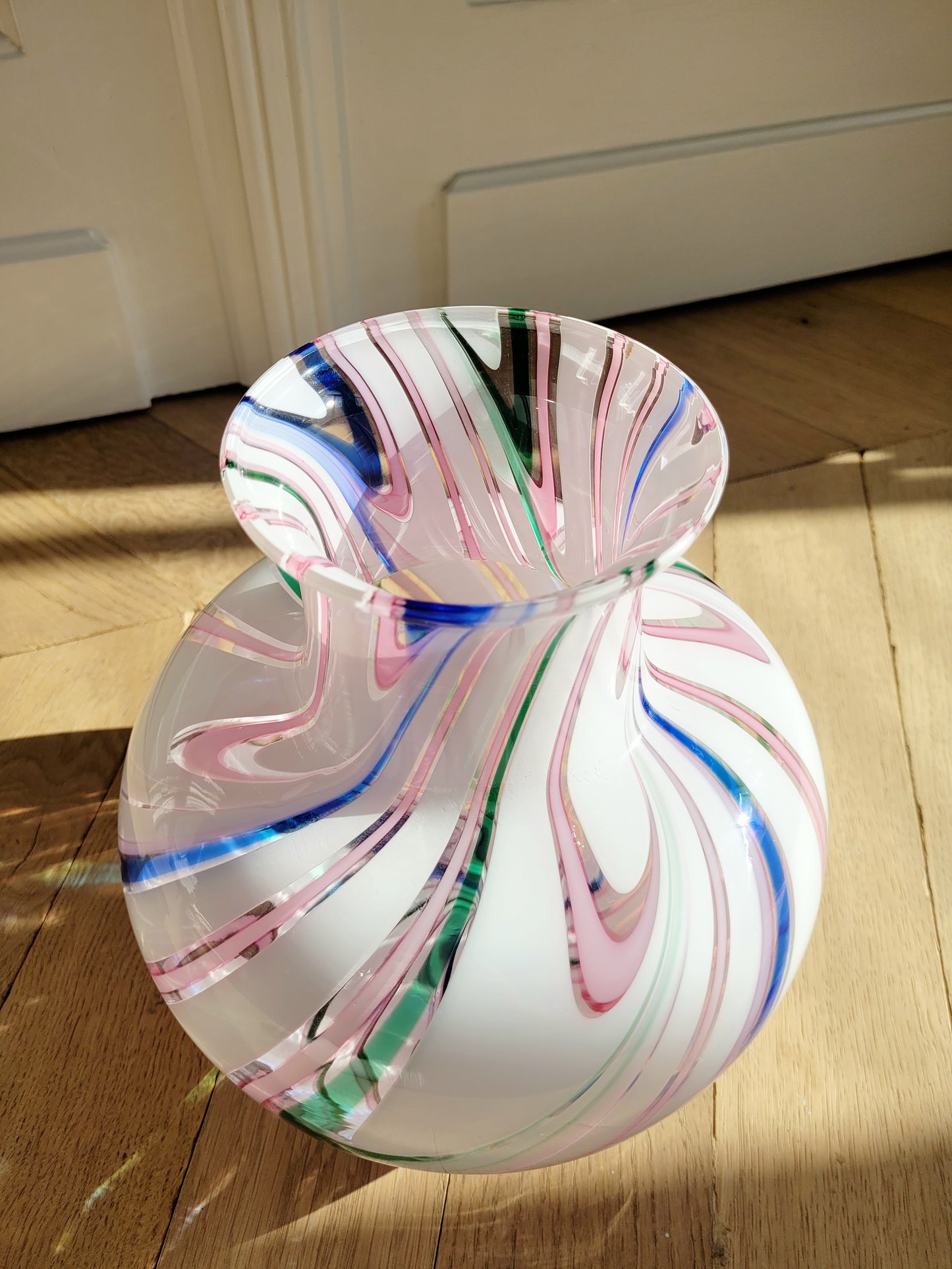side view of a vintage Michielotto Murano multi swirl vase in a multitude of hues