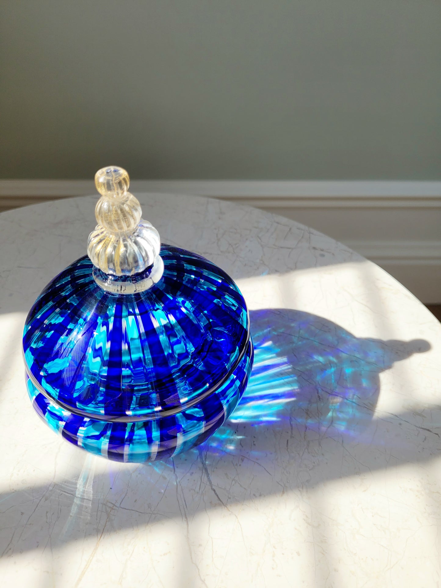 top view of a handcrafted vintage striped Murano bonbonniere in blue and gold