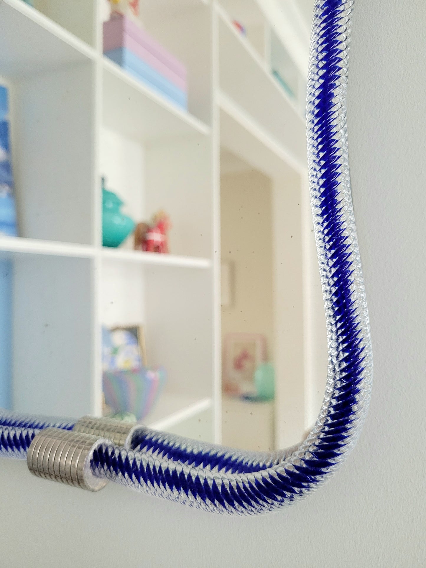 detail of a vintage Italian mirror, accentuated by a twisted frame of clear/blue Murano glass