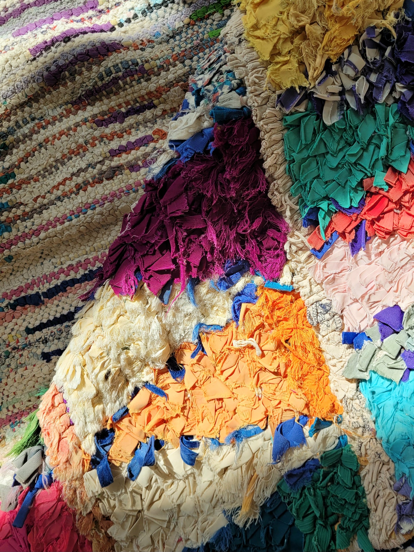 detailed view of a handwoven Boucherouite rug featuring vibrant colours