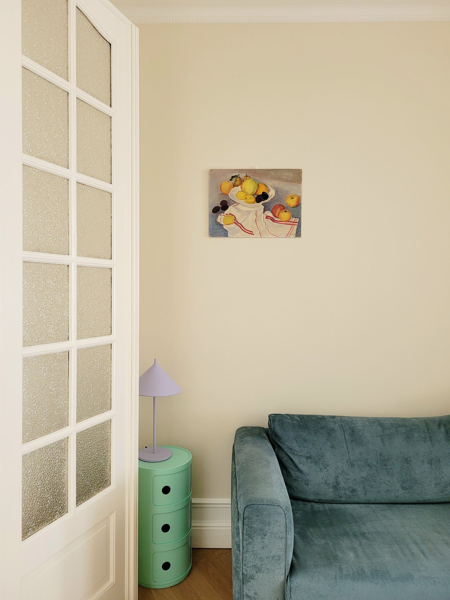 full view of an oil painting with still life of a fruit bowl on a tea towel
