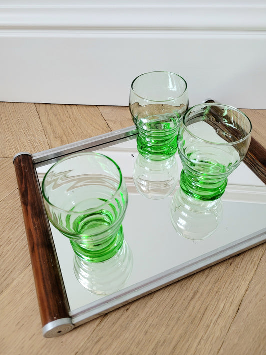 top view of bright green art deco drinking glasses on a mirror tray