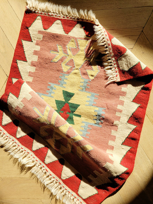 top view of a bright and colourful vintage kilim rug with geometrical pattern