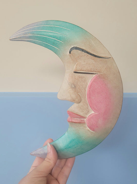 front view of a carved crescent moon to hang in a children's room