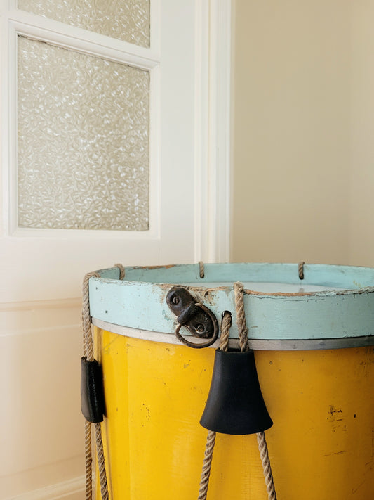 detail of a colourful rope tension drum in vibrant colours in use as a side table