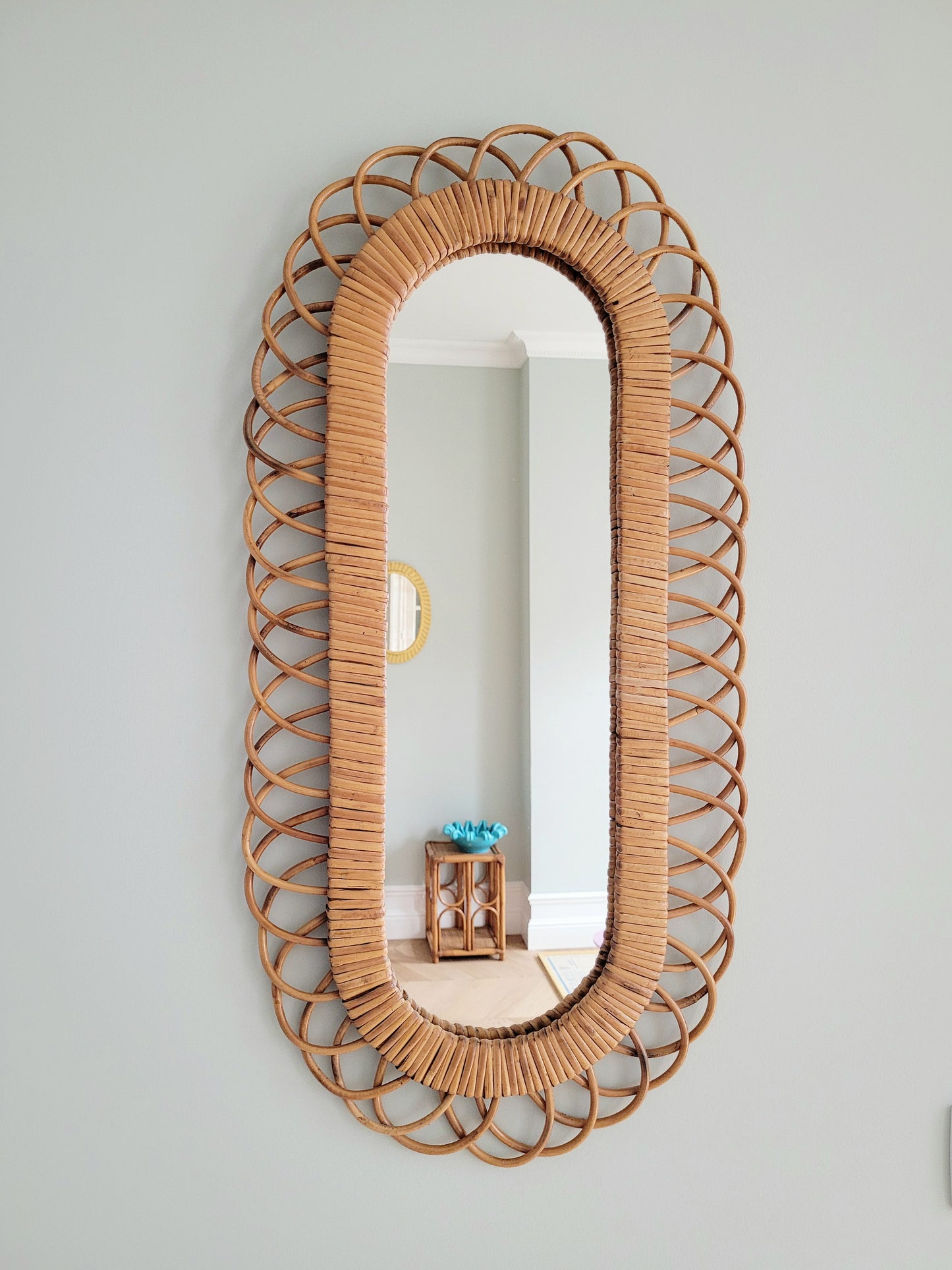 front view of an elongated vintage rattan wall mirror possibly from Franco Albini