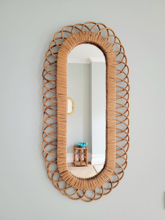 front view of an elongated vintage rattan wall mirror possibly from Franco Albini
